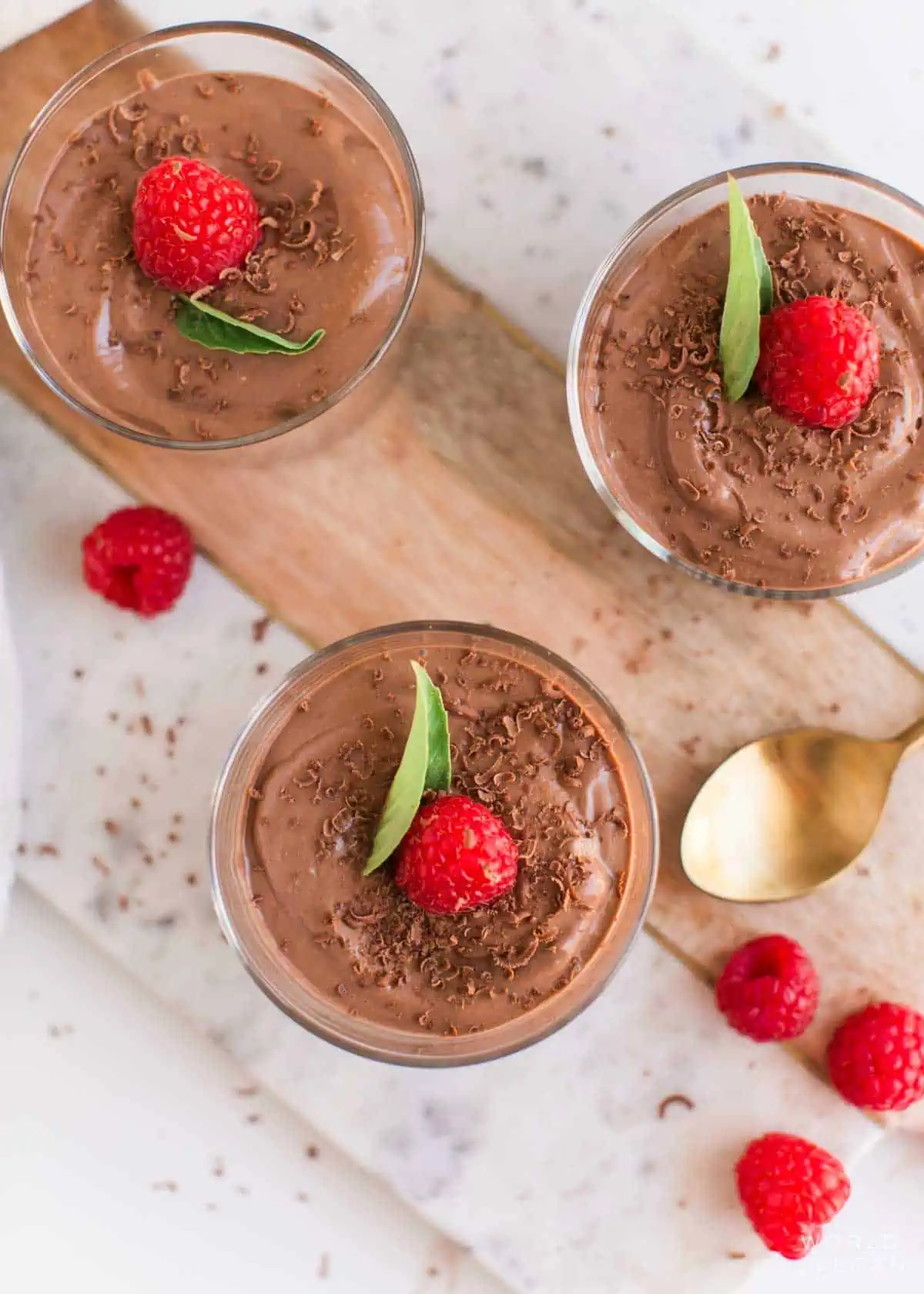 Overhead view of three jars filled with vegan chocolate mousse.