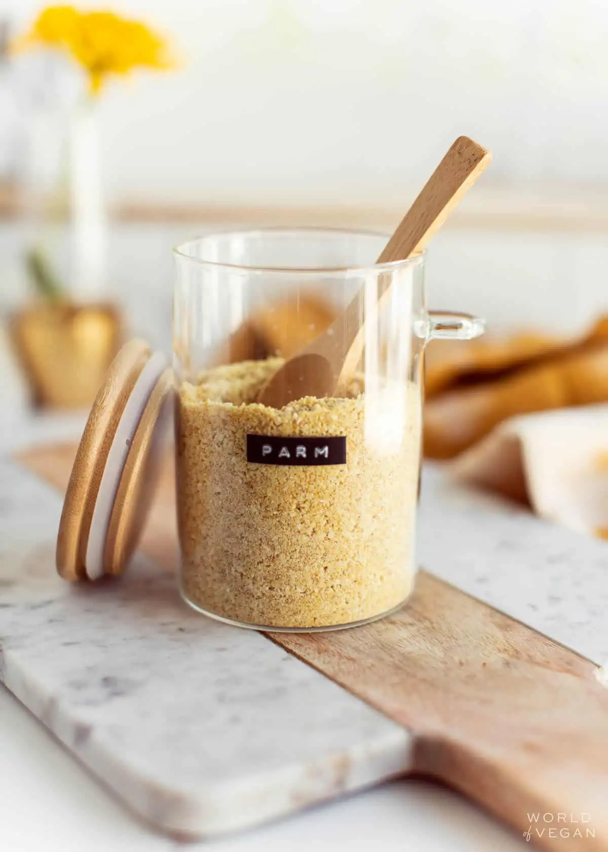 Homemade vegan parmesan cheese, stored in a glass container.