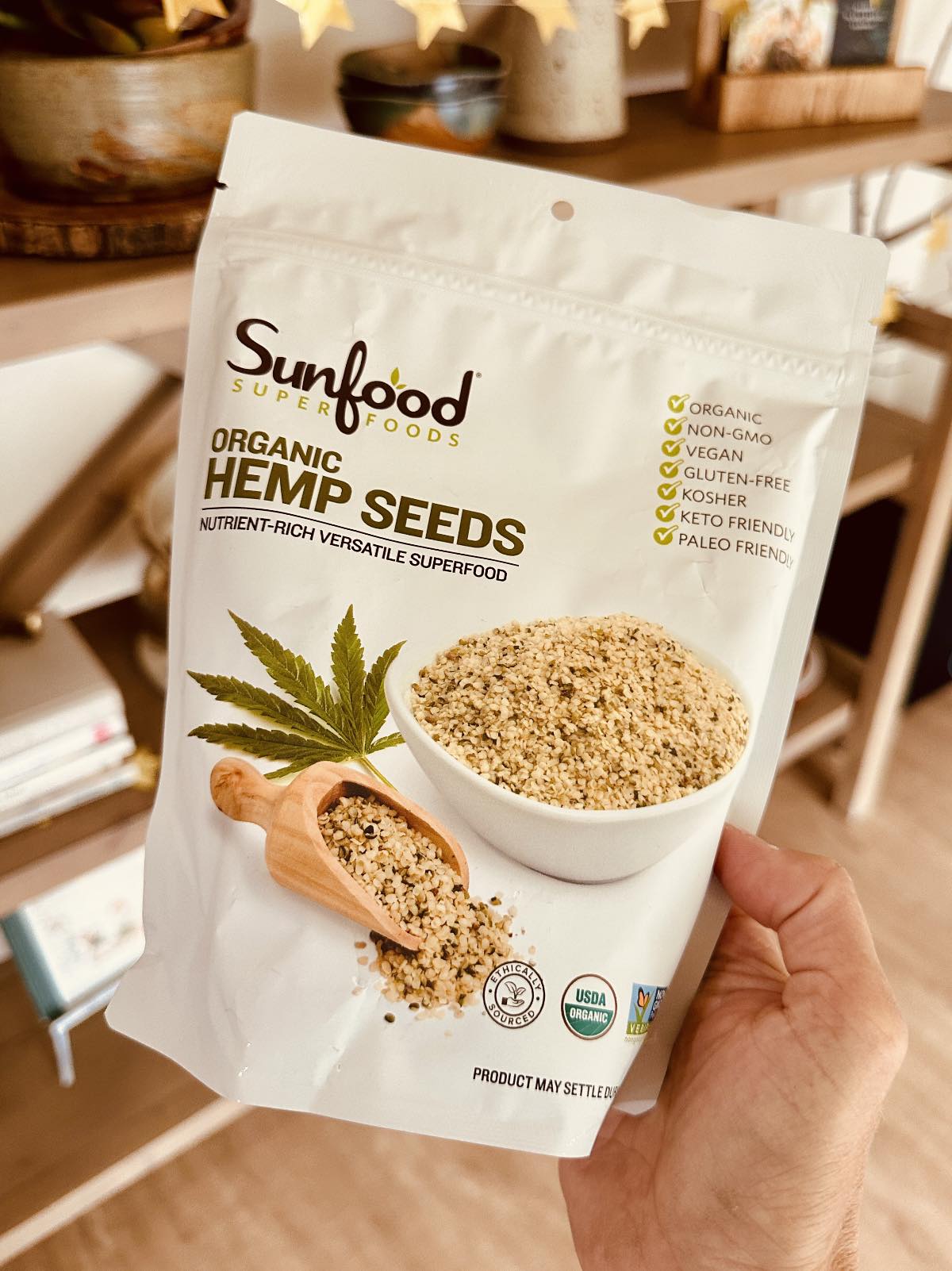 Holding out a bag of organic hemp seeds from Sunfoods.