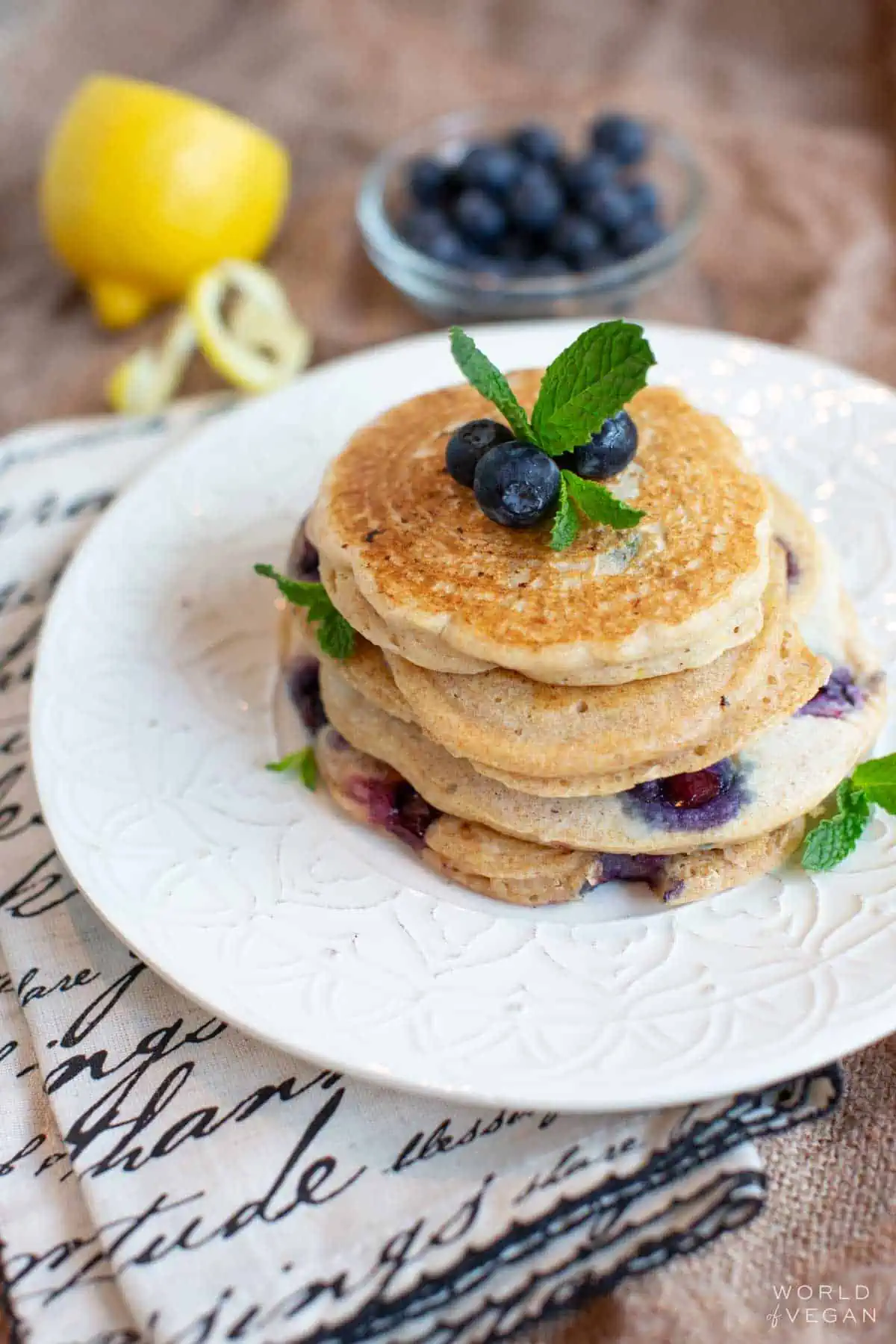 Eggless vegan blueberry pancakes stacked on a plate.