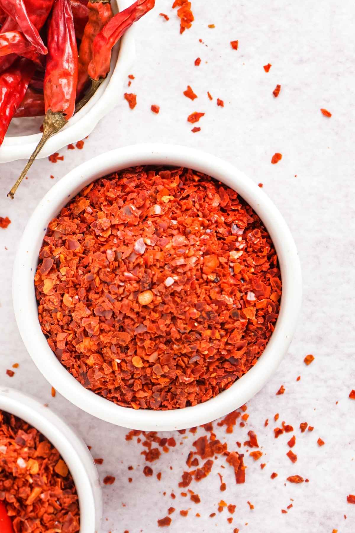 A small ramekin of dried, ground peppers,