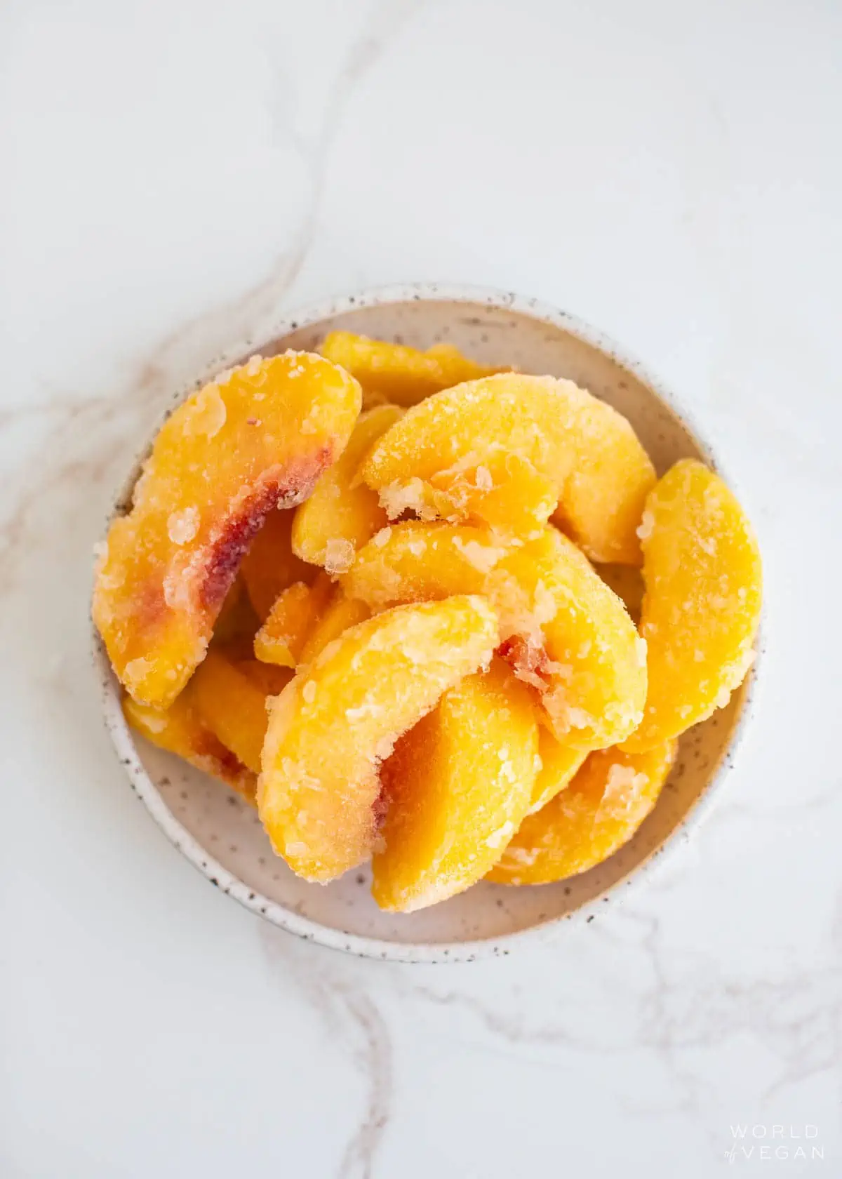 A bowl of frozen peaches.