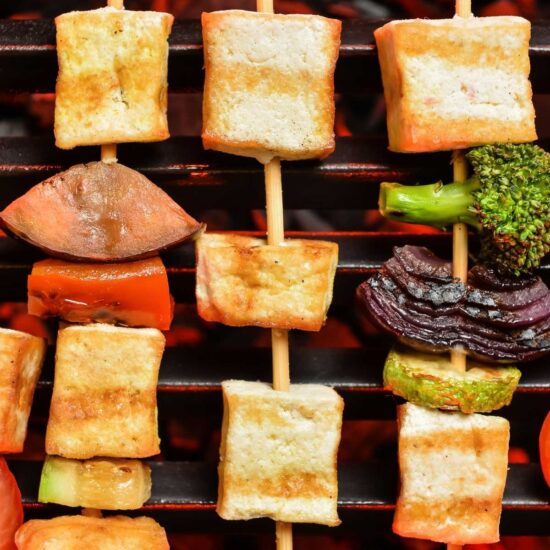 Grilled tofu and veggies on wooden skewers.