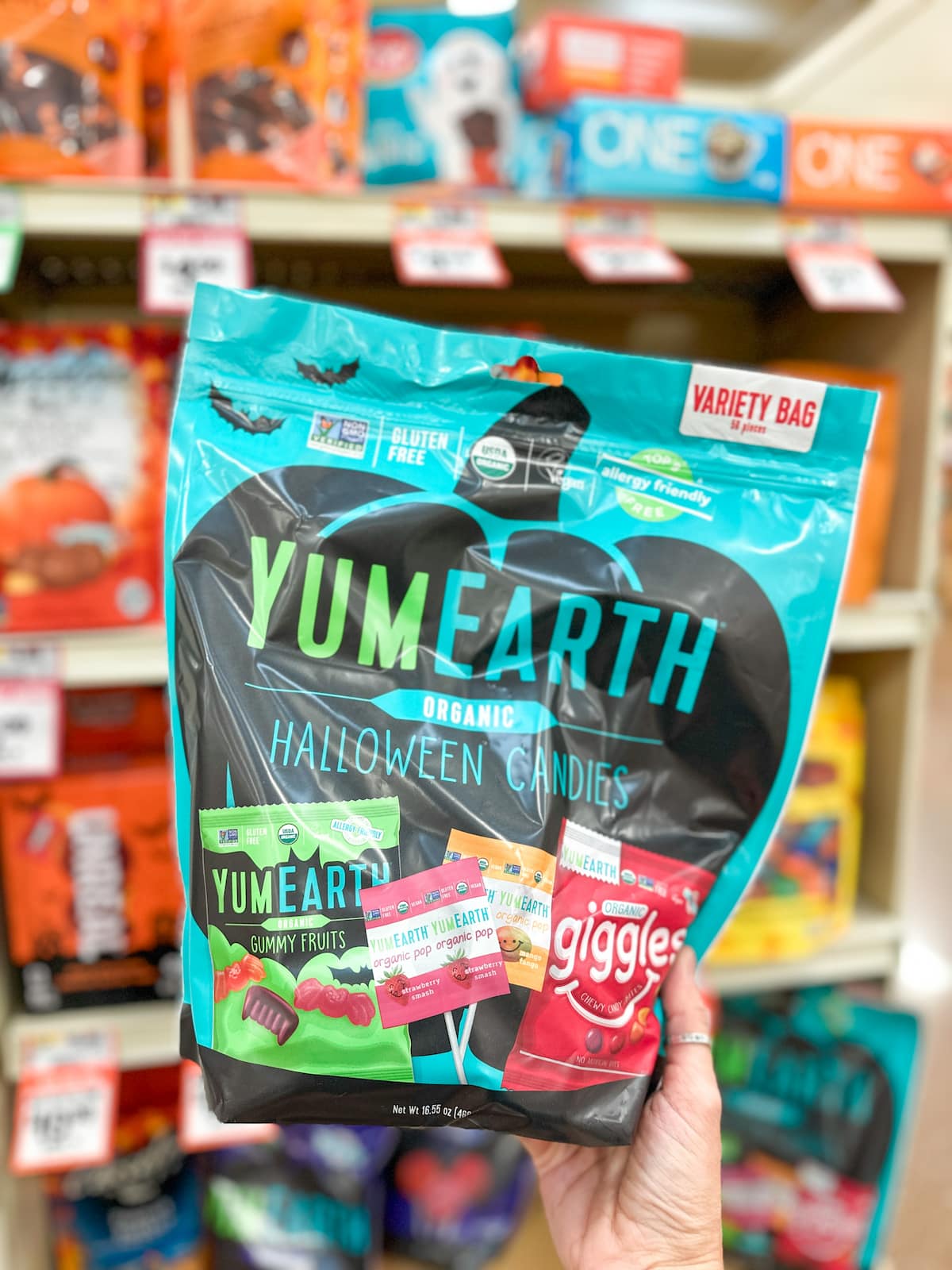A variety pack of Yum Earth Halloween Candies including gummy fruit, lollipops, and giggles.
