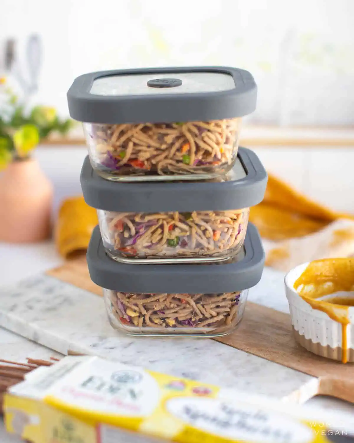 Peanut noodle salad placed into meal prep containers.