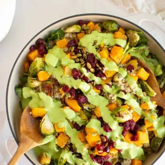 Quinoa arugula salad with Brussels sprouts, butternut squash, and a drizzle of creamy dill dressing.