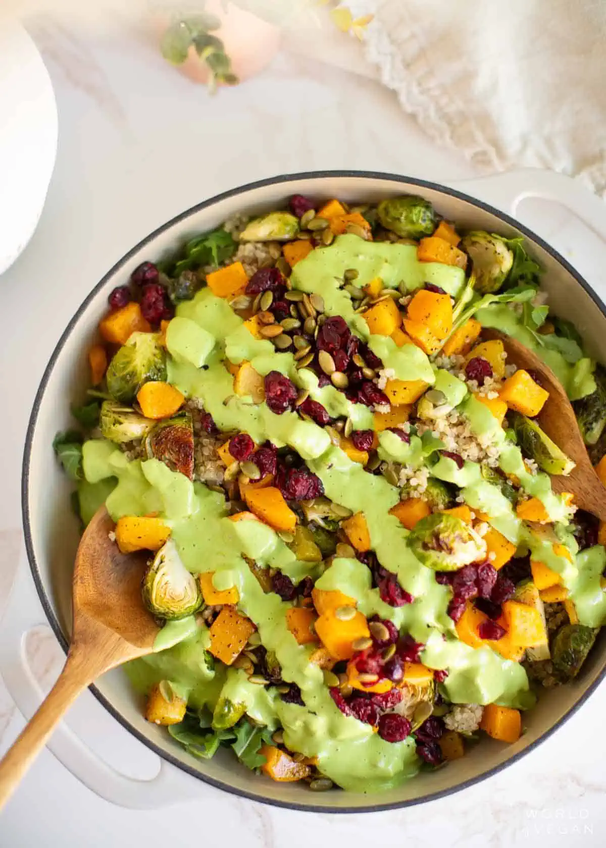 Quinoa arugula salad with Brussels sprouts, butternut squash, and a drizzle of creamy dill dressing.