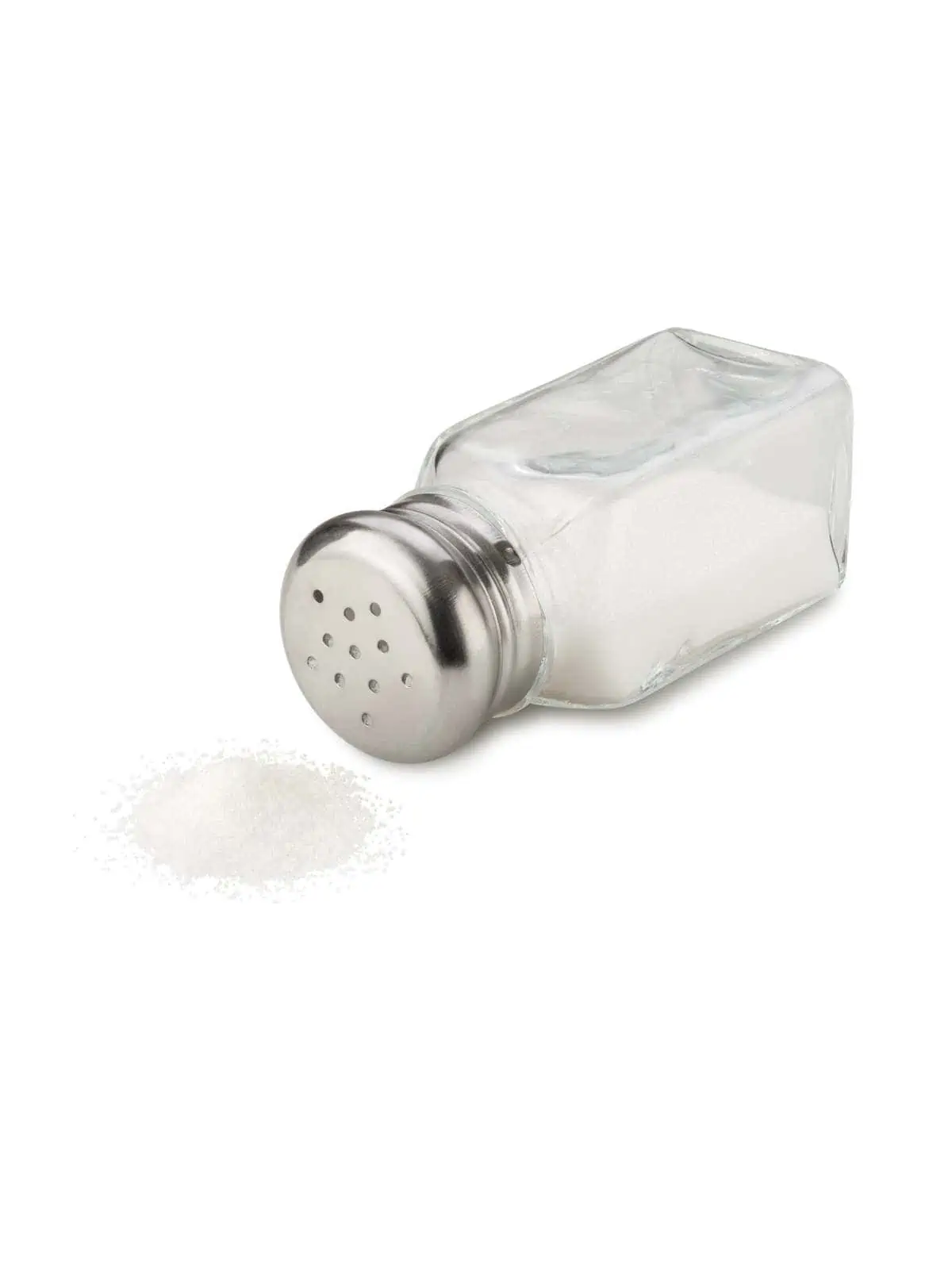 A shaker of iodized table salt on its side with white salt spilling out. 