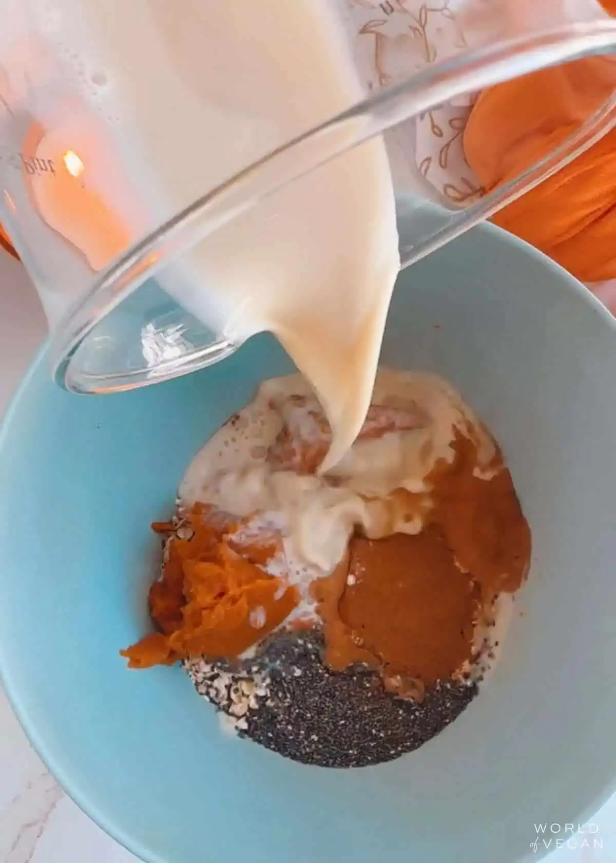 A mixing bowl full of ingredients to make the pumpkin oatmeal bites.