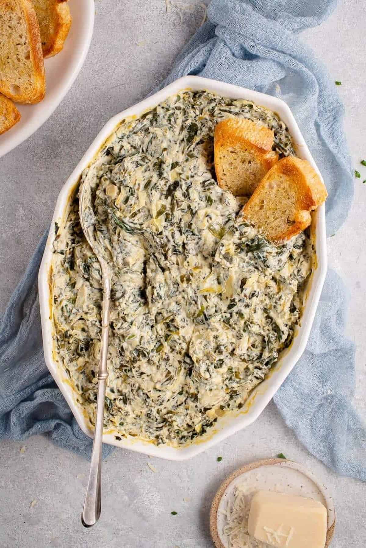 A casserole dish with vegan artichoke dish made with silken tofu.