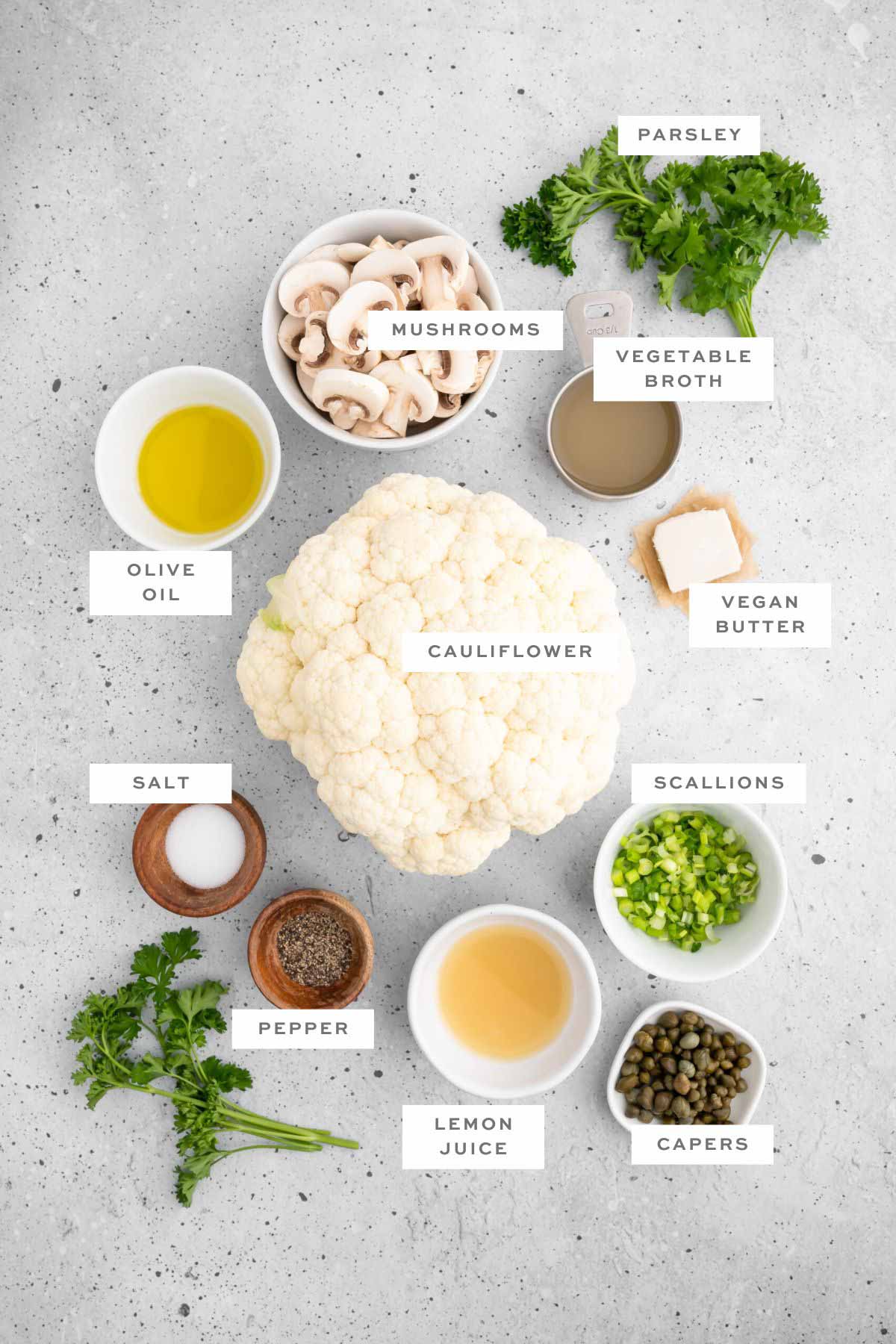 Ingredients for roasted cauliflower steak with labels.