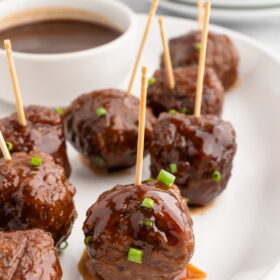 Vegan bbq sauce meatballs served on a platter with toothpicks.
