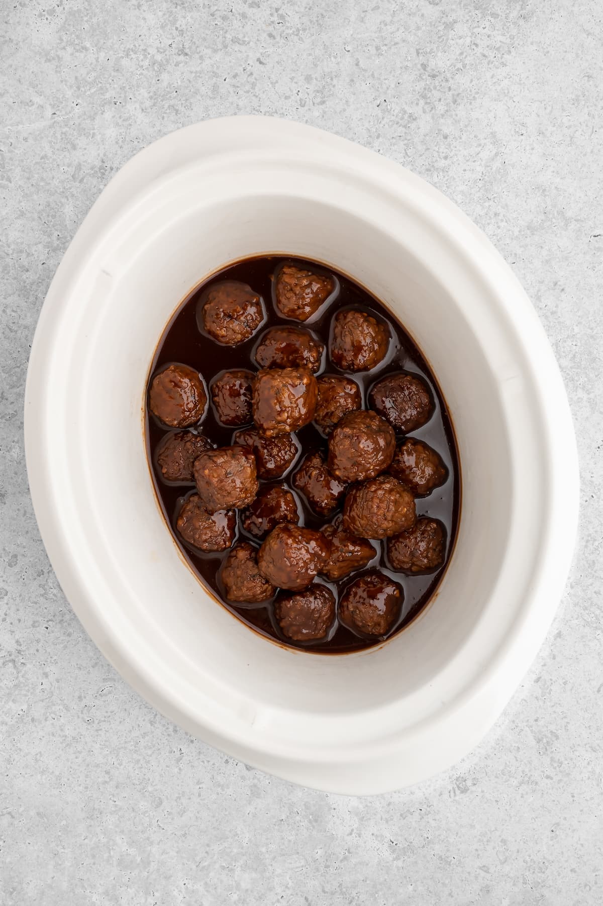 The vegan bbq sauce meatballs in the slow cooker after cooking.