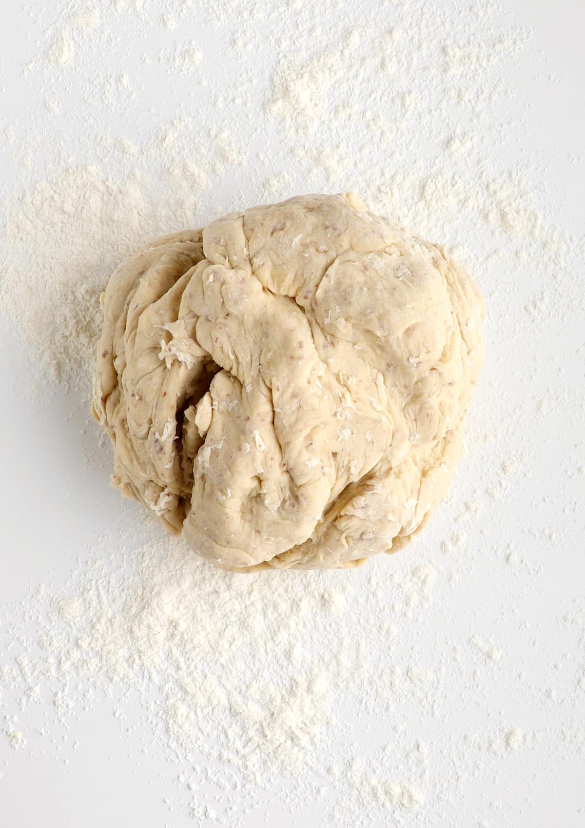 Vegan cinnamon roll dough rolled into a ball.