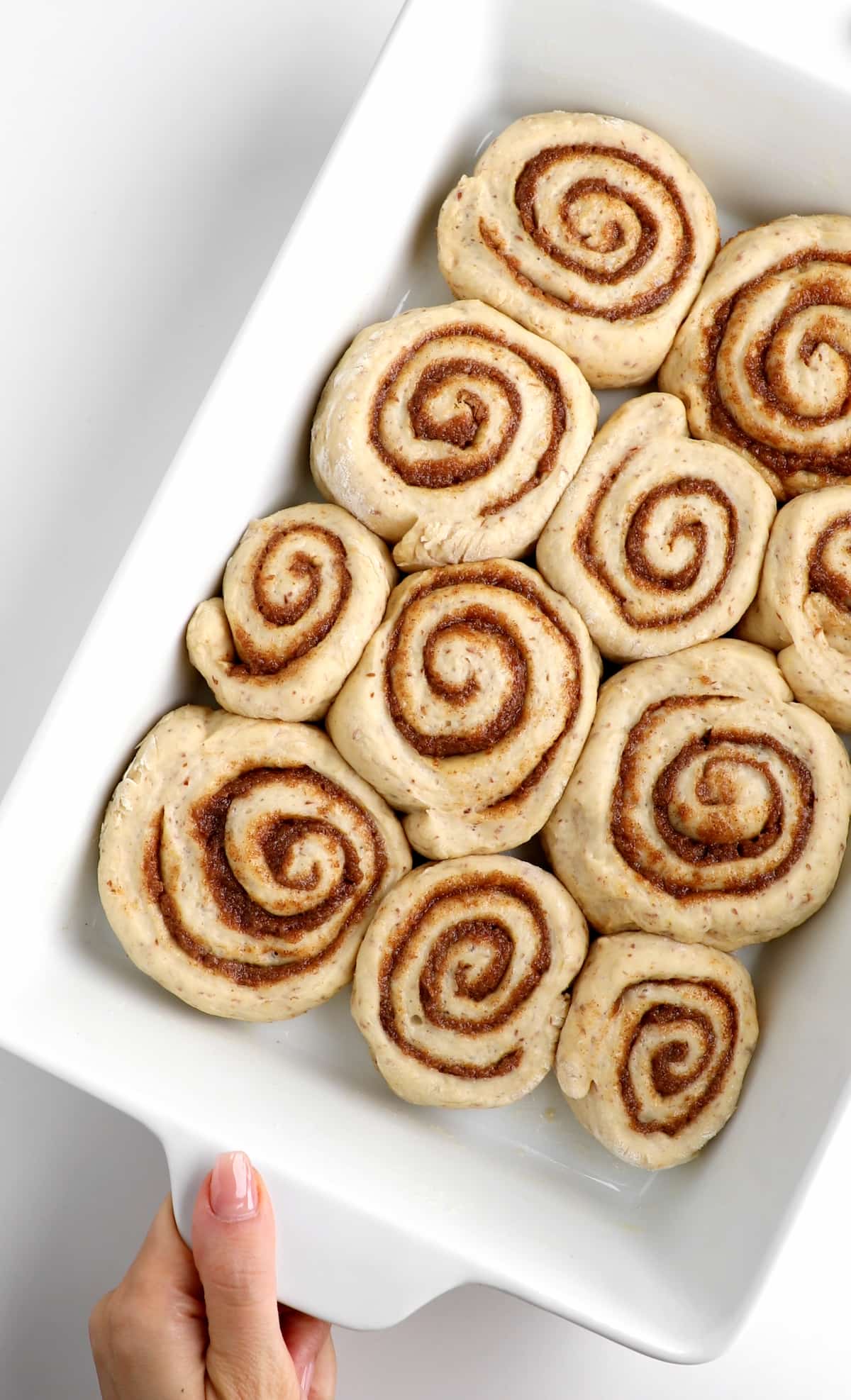 Vegan cinnamon rolls in a baking dish.