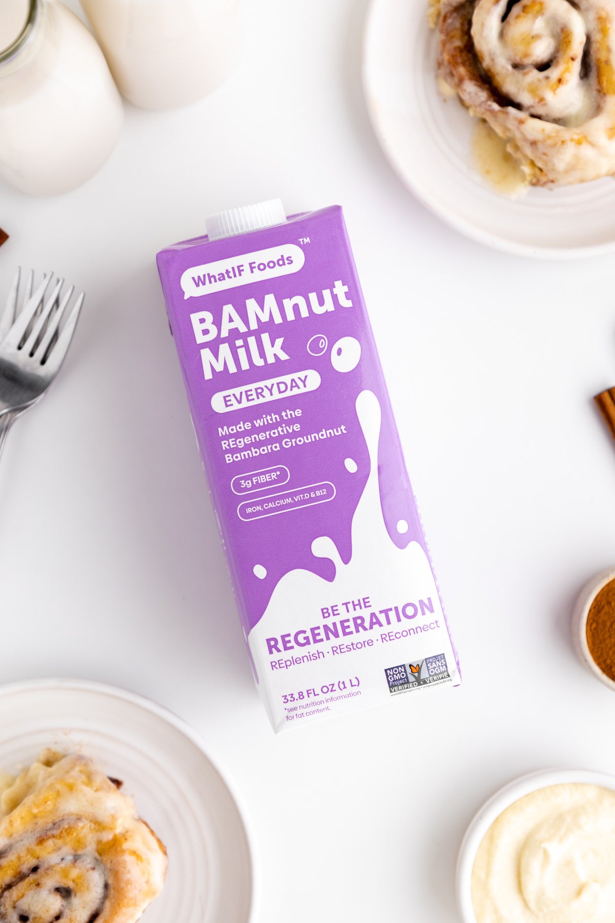 Vegan milk made from bambara groundnuts called BamNut milk from WhatIF Foods surrounded by cinnamon roll ingredients. 
