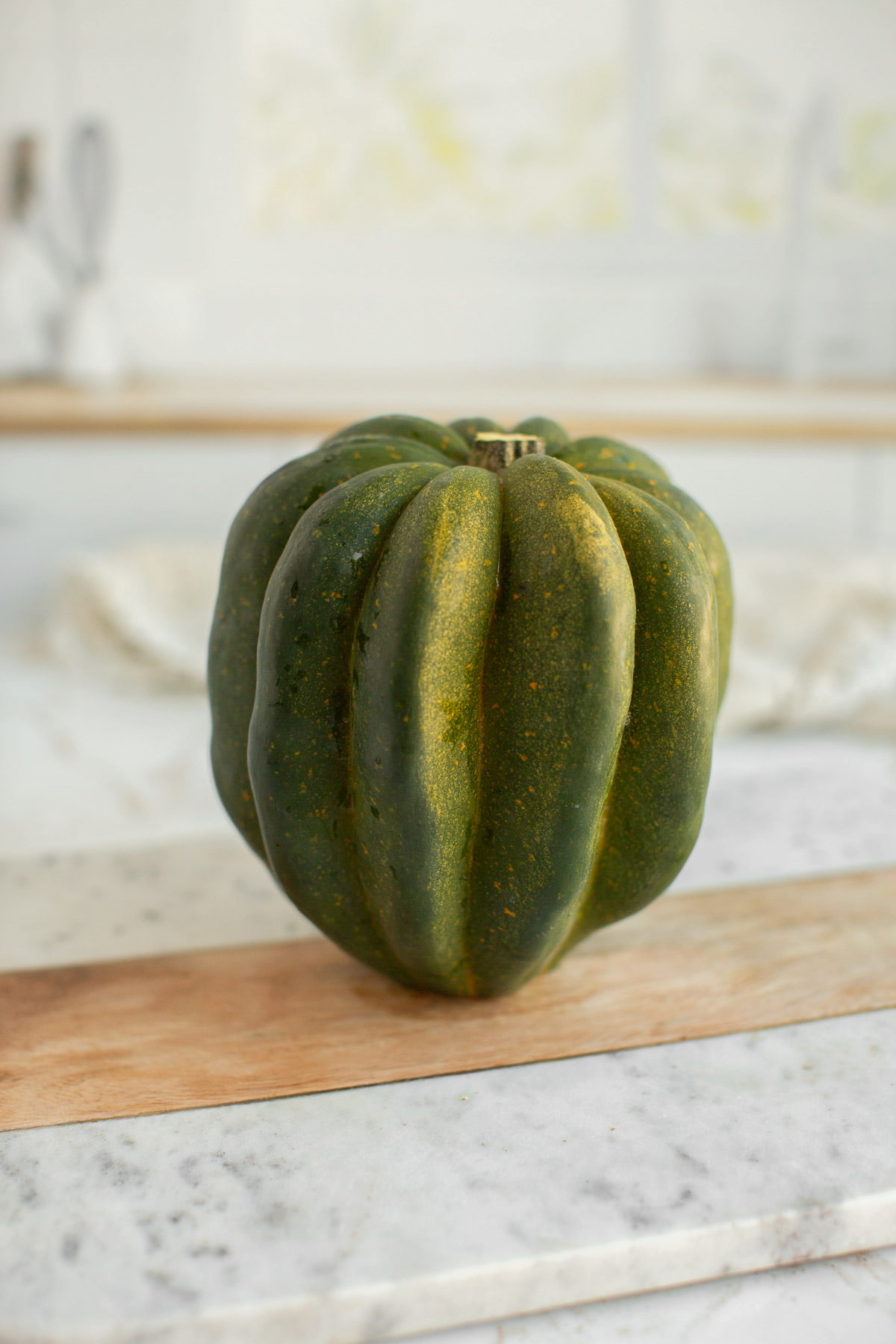 An acorn squash on a tabletop.