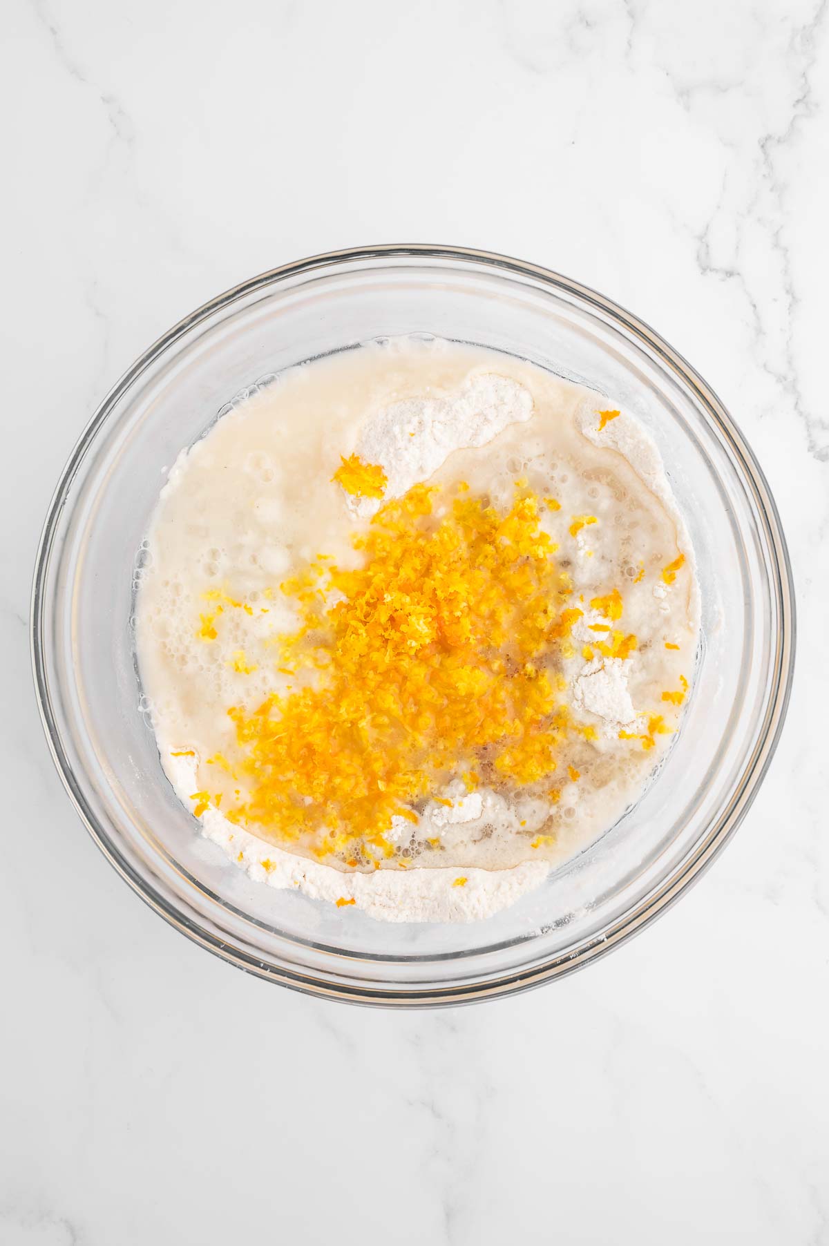 Bread batter with grated orange zest on top.