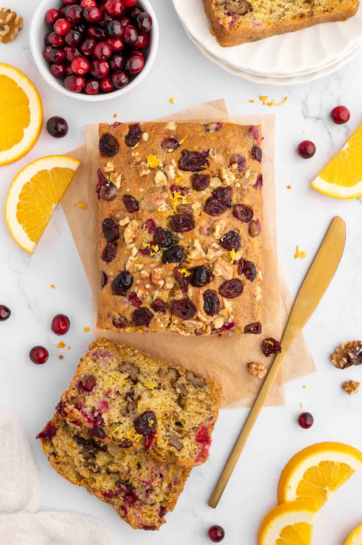 A sliced loaf of walnut cranberry bread.