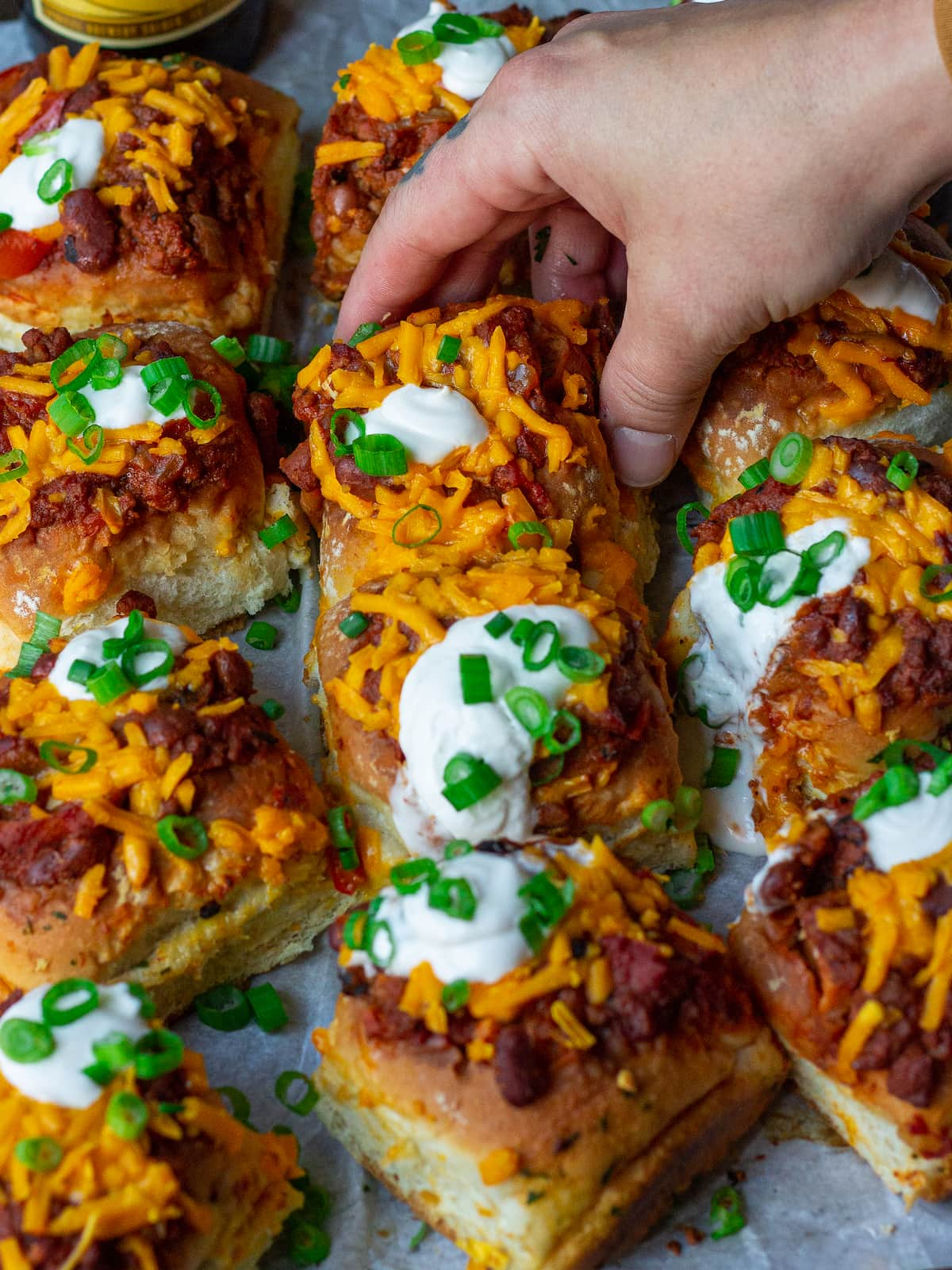 A tray of vegan mini chili cheese dogs.