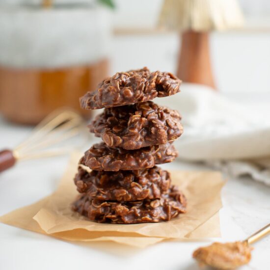 A stack of vegan no-bake cookies on wax paper.