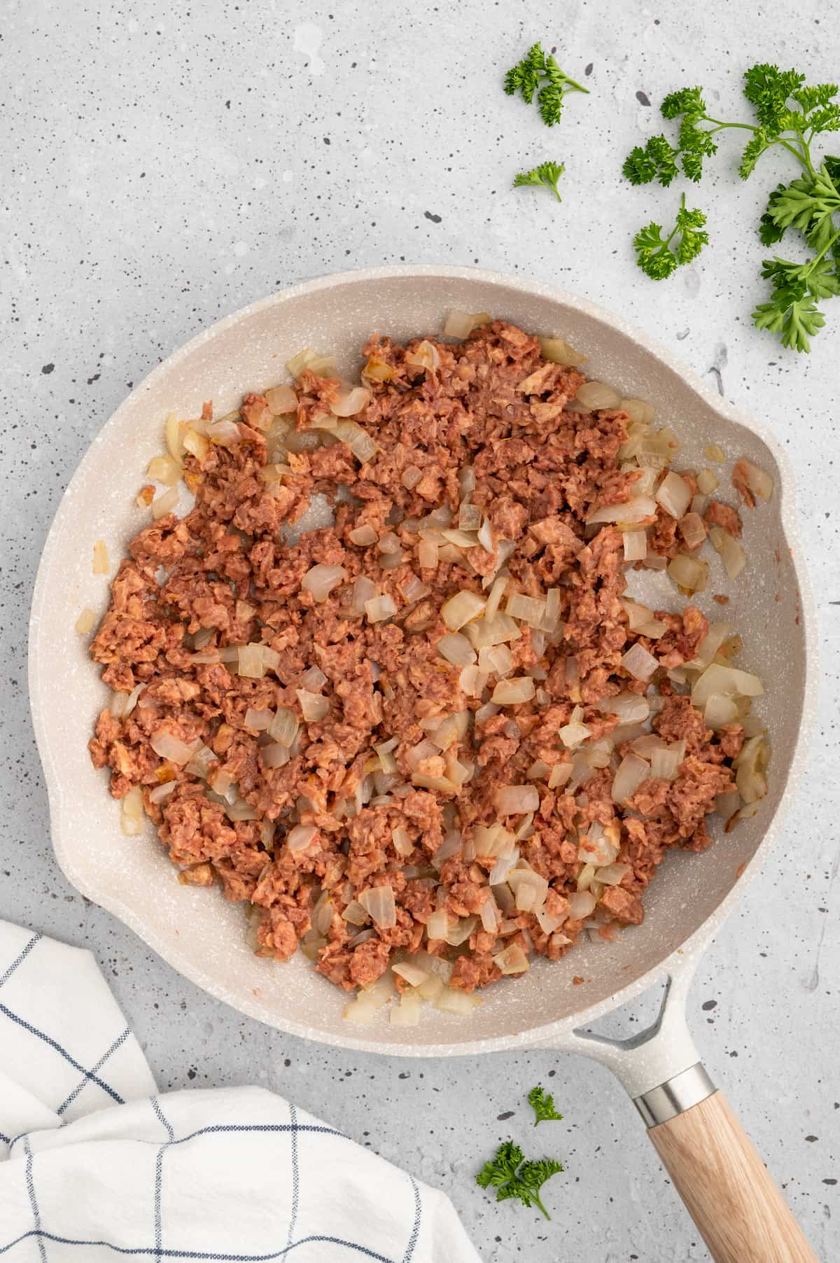 Vegan ground beef added to the skillet of caramelized onions.