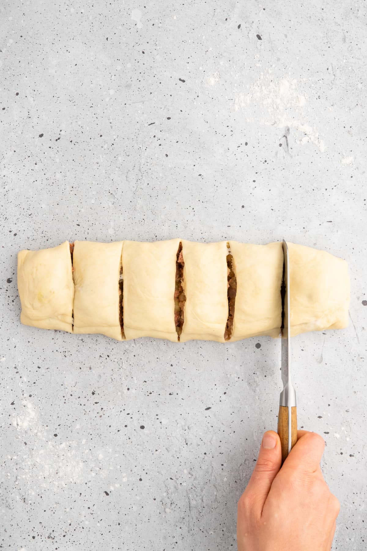 Slicing the knish into six even pieces.