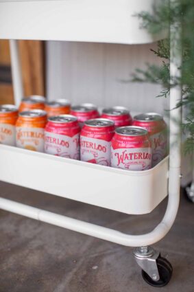 Waterloo sparkling water cans and drinks set up in colorful order in the bottom of the snack cart.