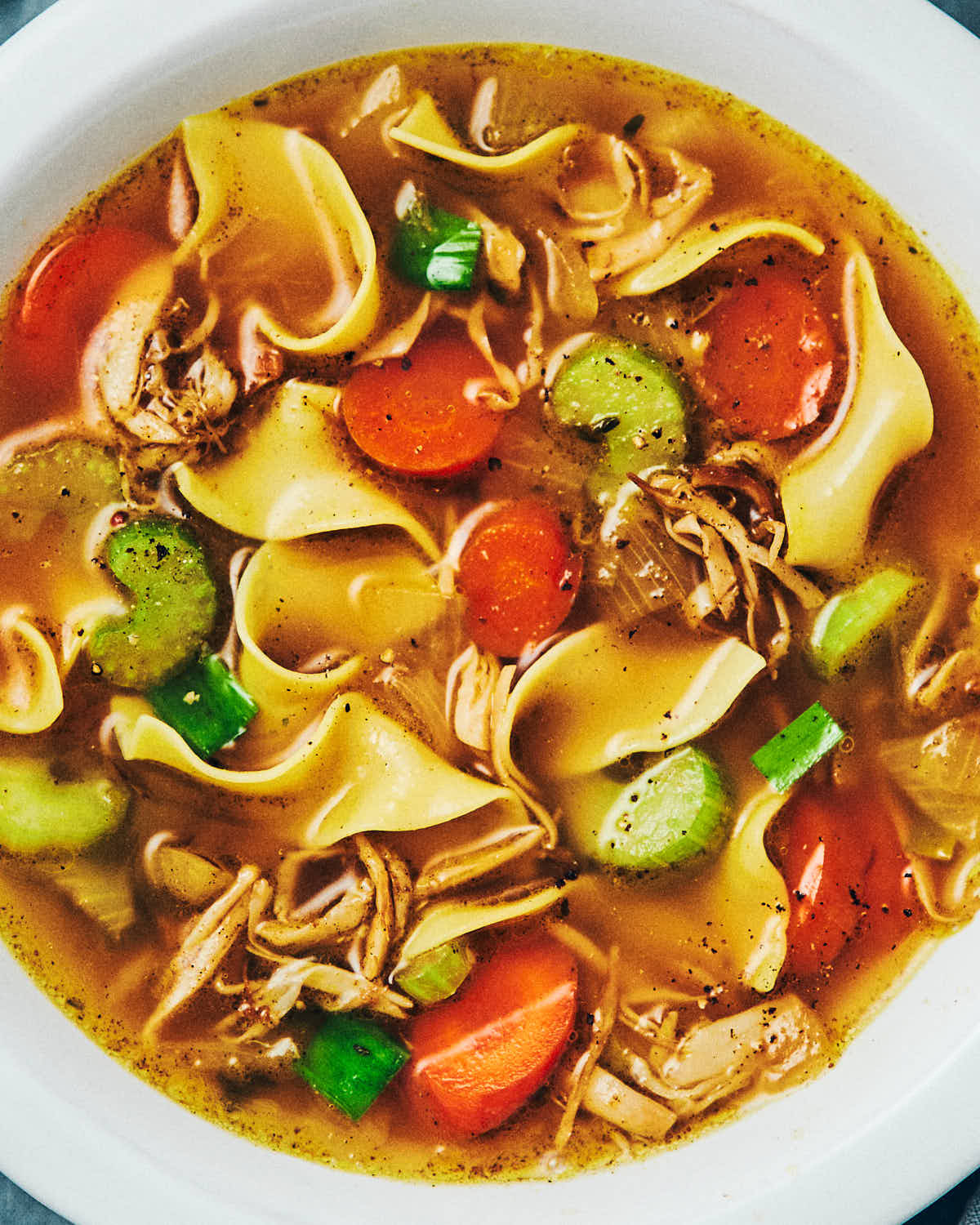 A bowl of vegan chicken noodle soup with oyster mushrooms used as the chicken.