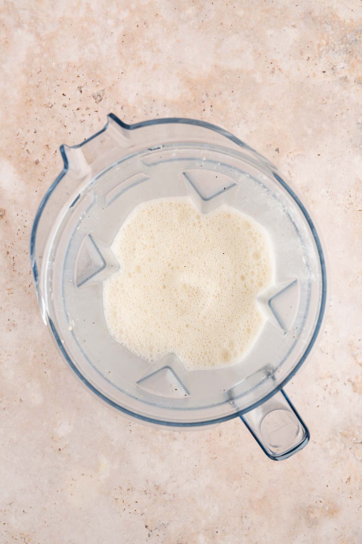 Broth, cashews, salt, and black pepper blended smooth in a blender pitcher.