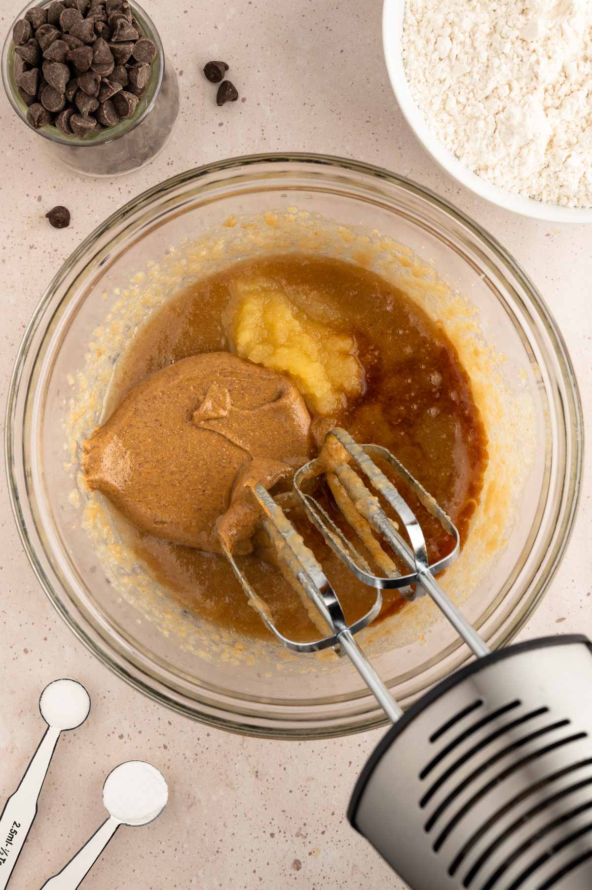 Cookie dough batter being mixed in a bowl.