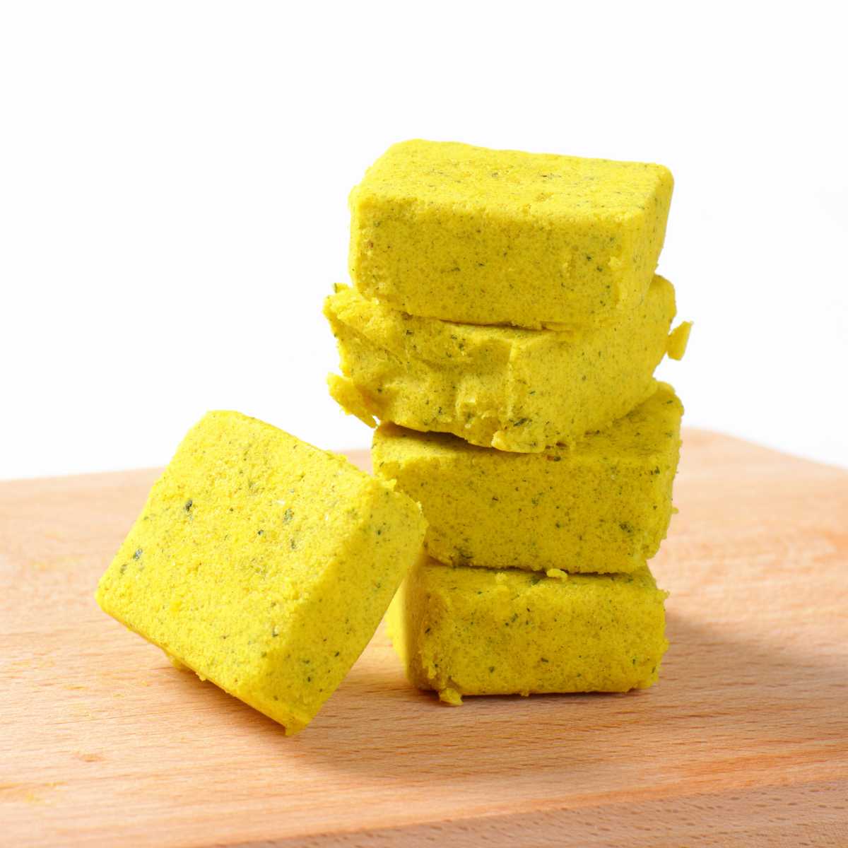 A stack of vegetarian bouillon cubes on a cutting board.