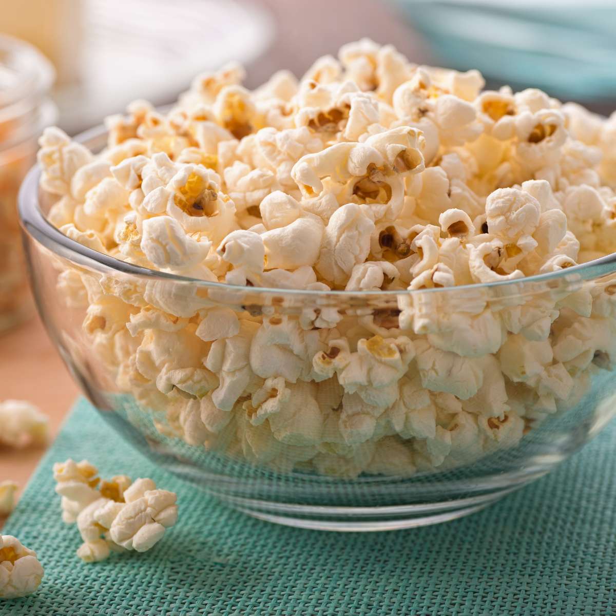 A glass bowl of popped vegan popcorn.