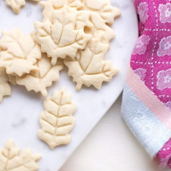 Vegan sugar cookies shaped like leaves.
