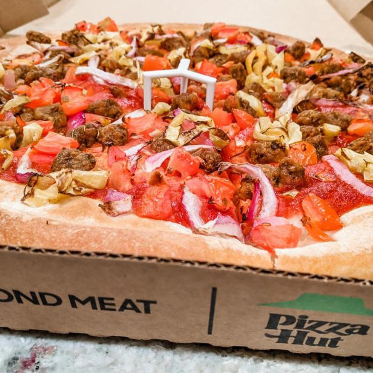 A vegan pizaa option from Pizza Hut with plant-based sausage.