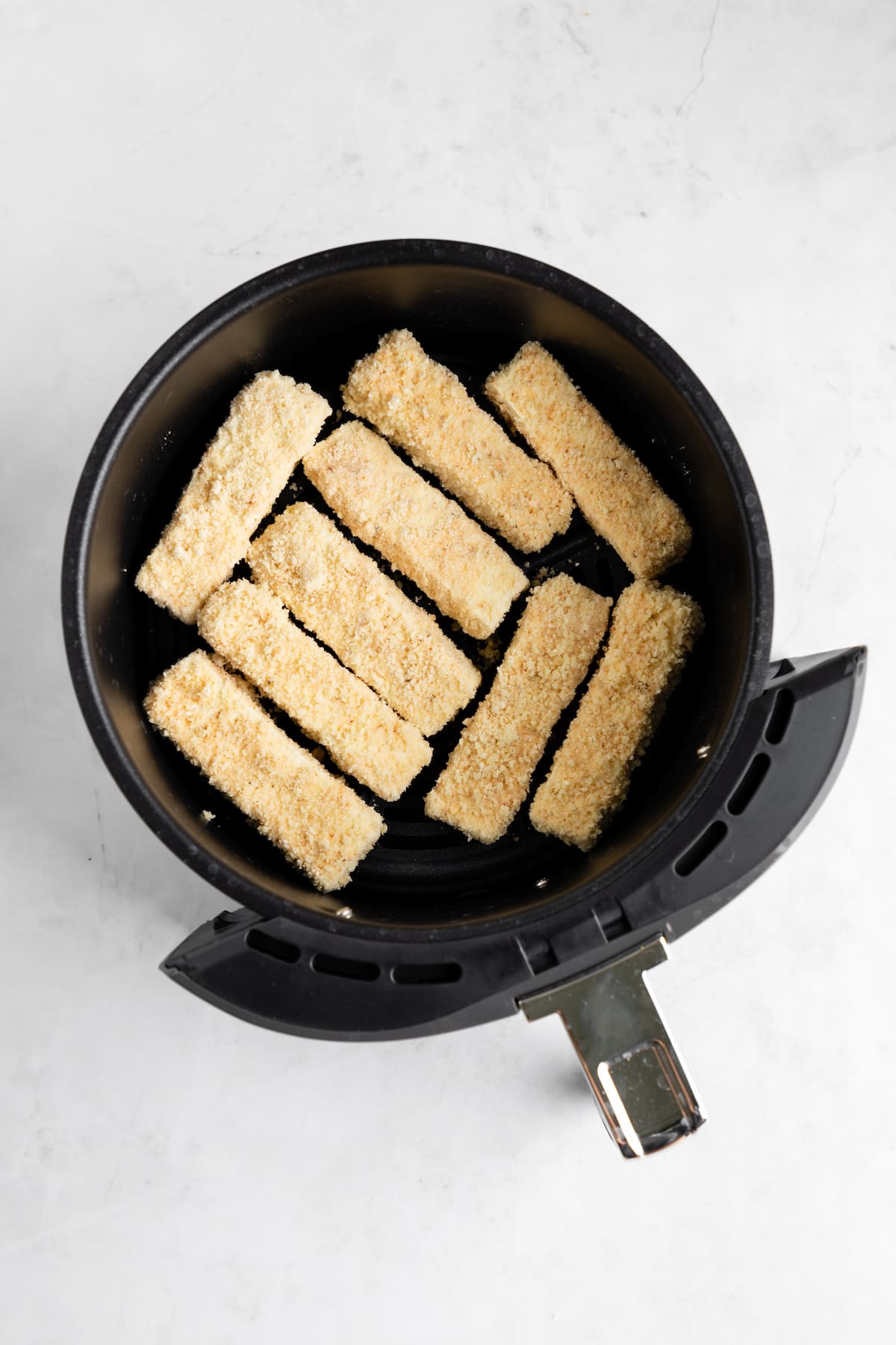 Battered tofu wings in an air fryer.