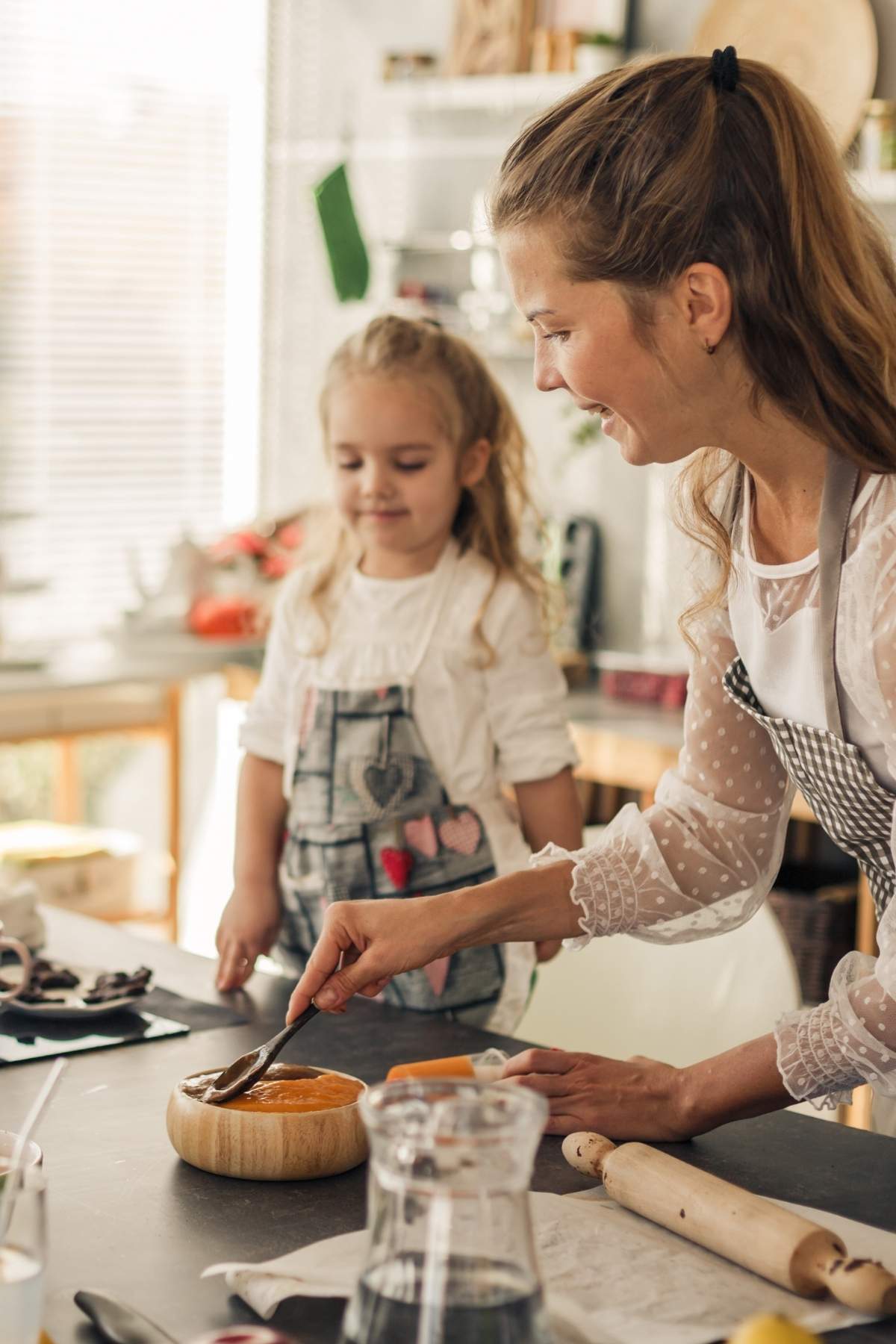A mother and daughter making vegan snacks in a kitchen.