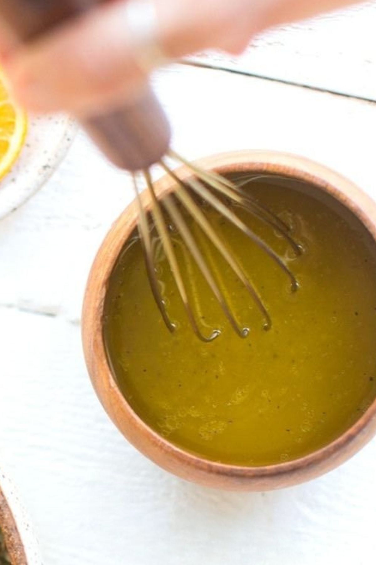 Vegan dressing bring whisked in a bowl. 