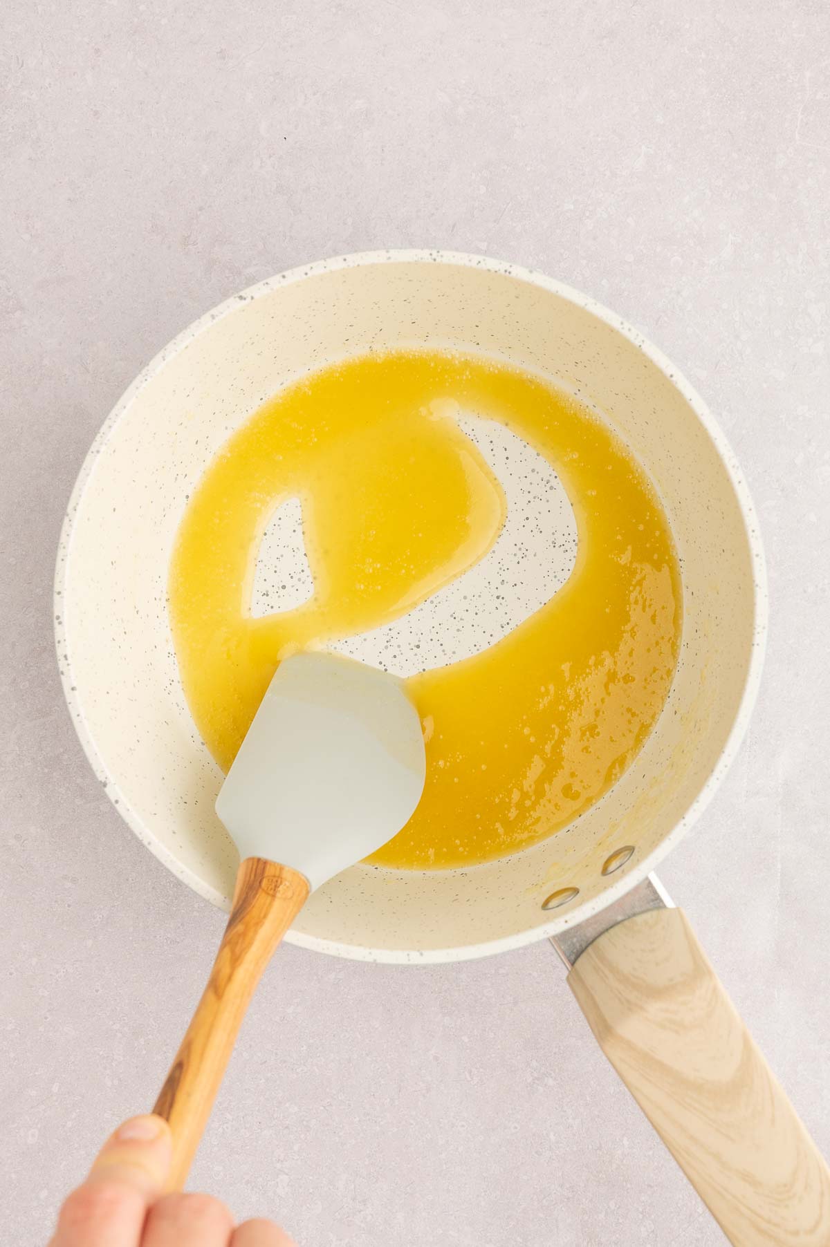 Thickened vegan carbonara sauce in a saucepan, made with soy milk, tofu, and kala namak.