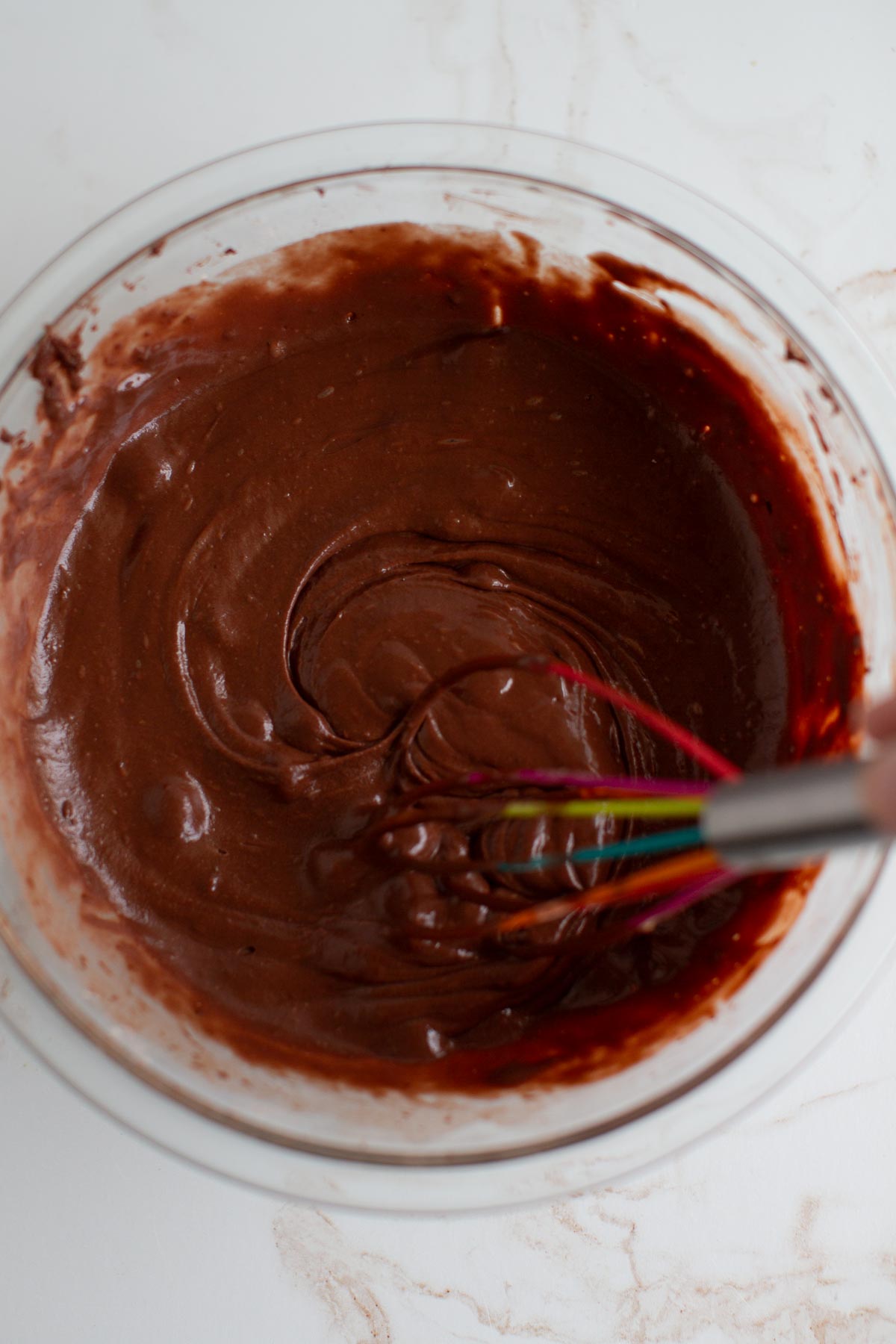 Mixed batter of vegan chocolate bundt cake in a bowl.