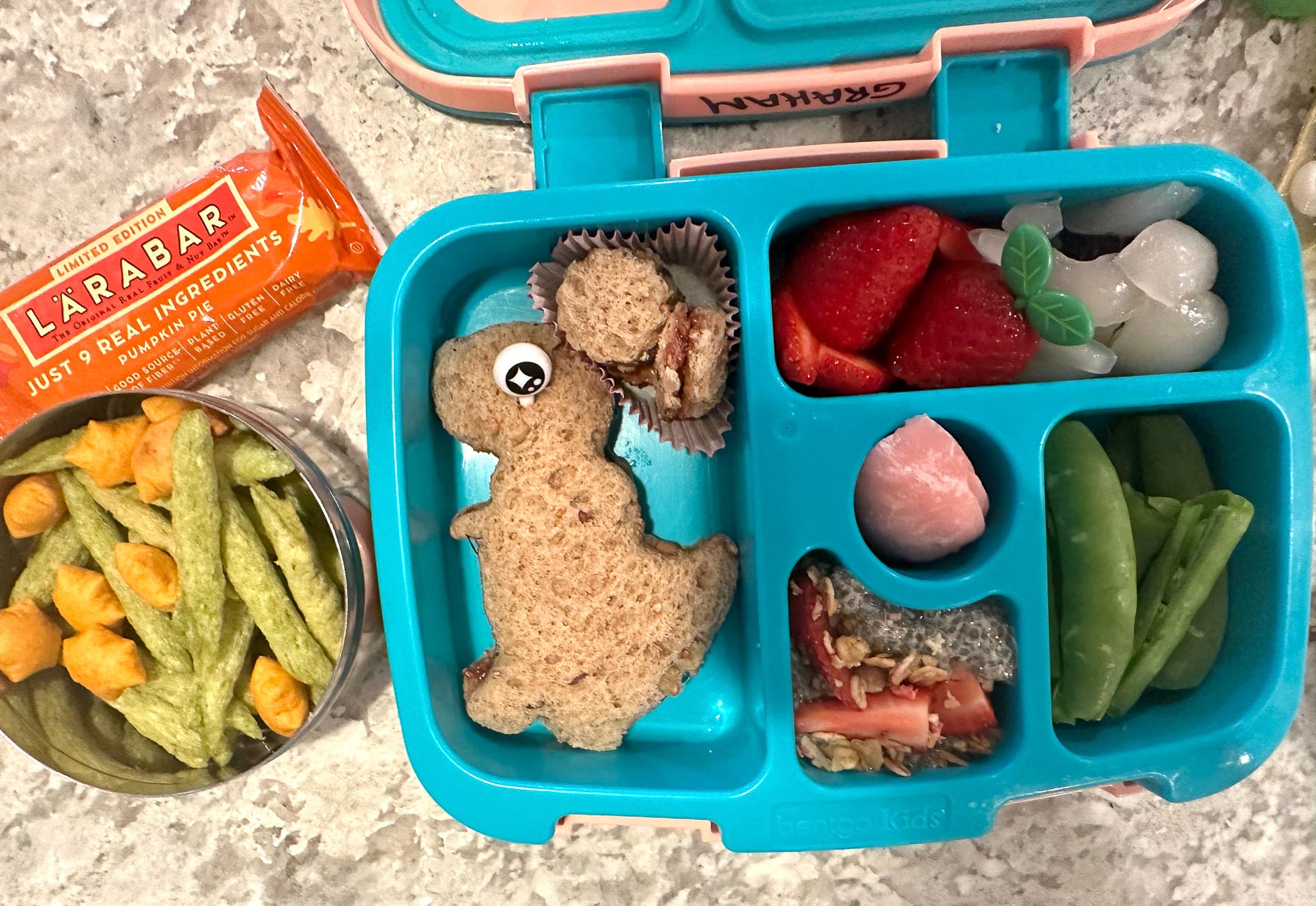 Fun dinosaur-themed vegan lunchbox packed with healthy snacks for kids.
