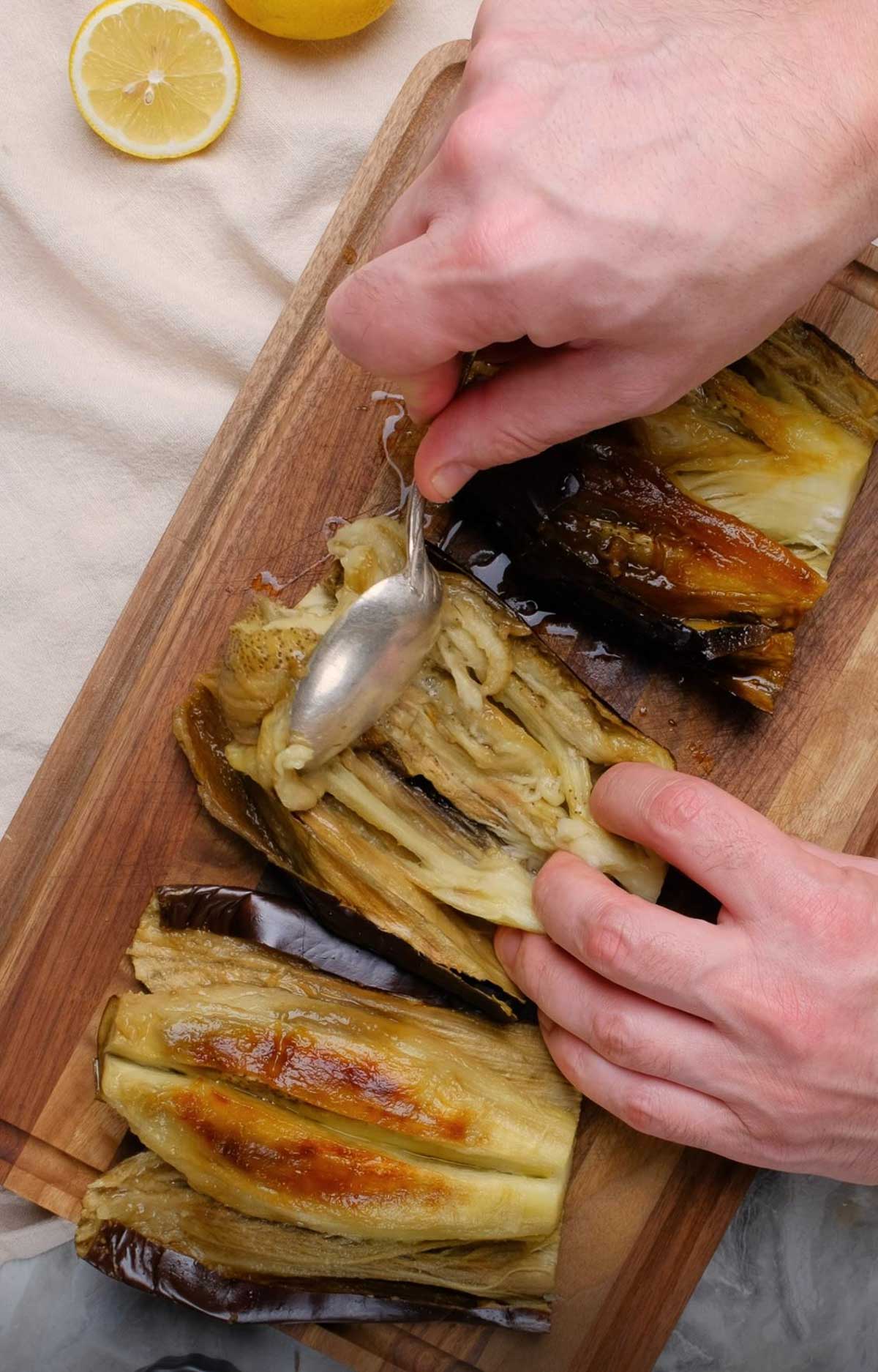 The interior of an eggplant being scooped out.