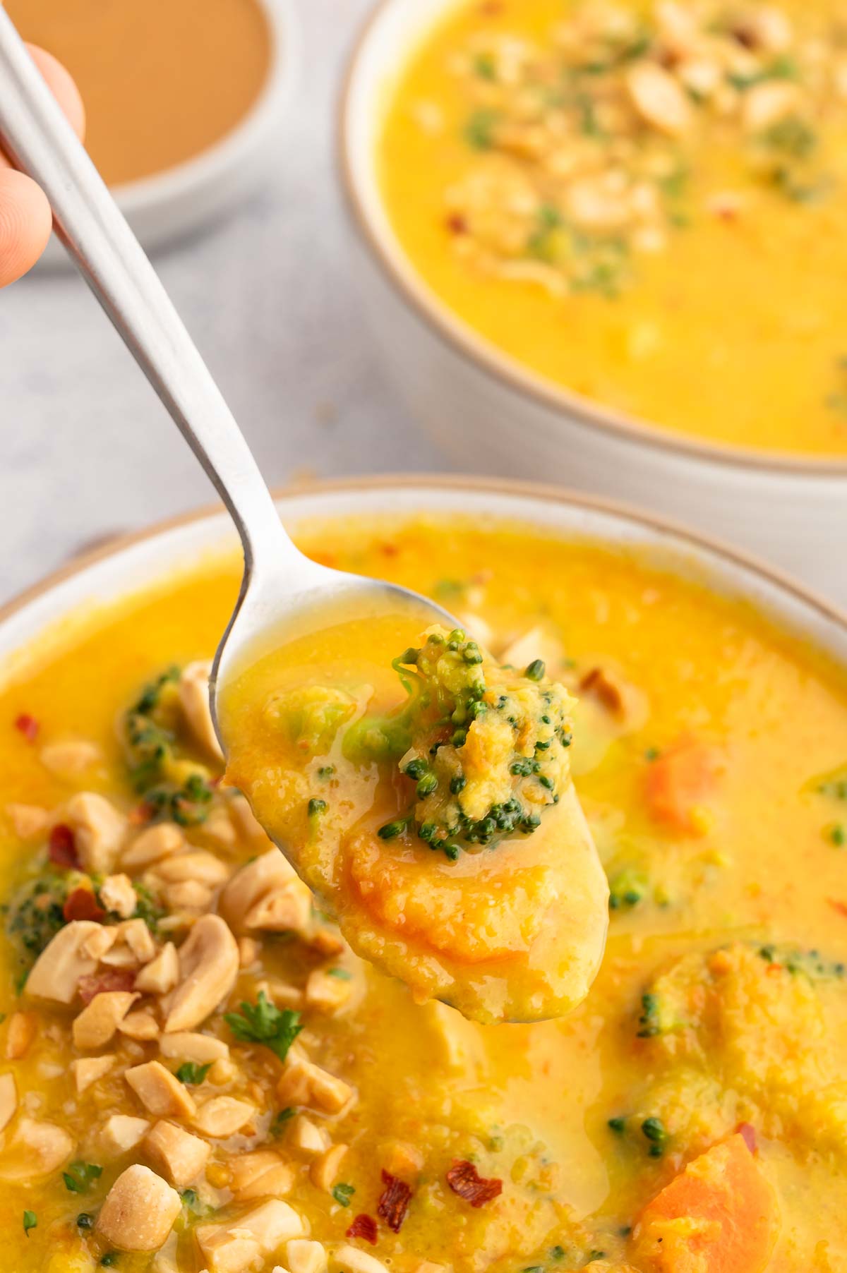 A spoonful of broccoli and peanut butter soup.