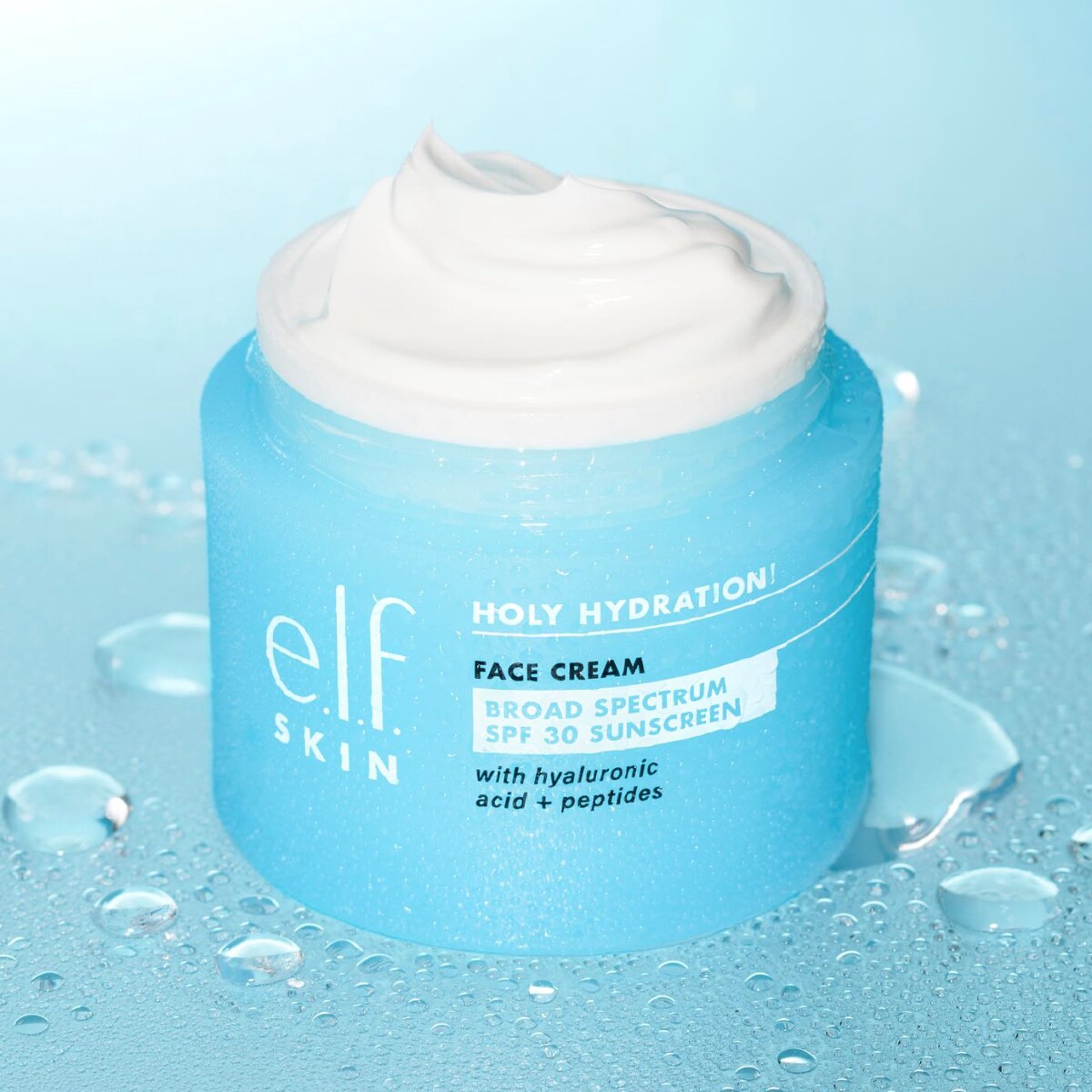 A light blue jar of face cream by the brand E.L.F. against a pale blue watery background.