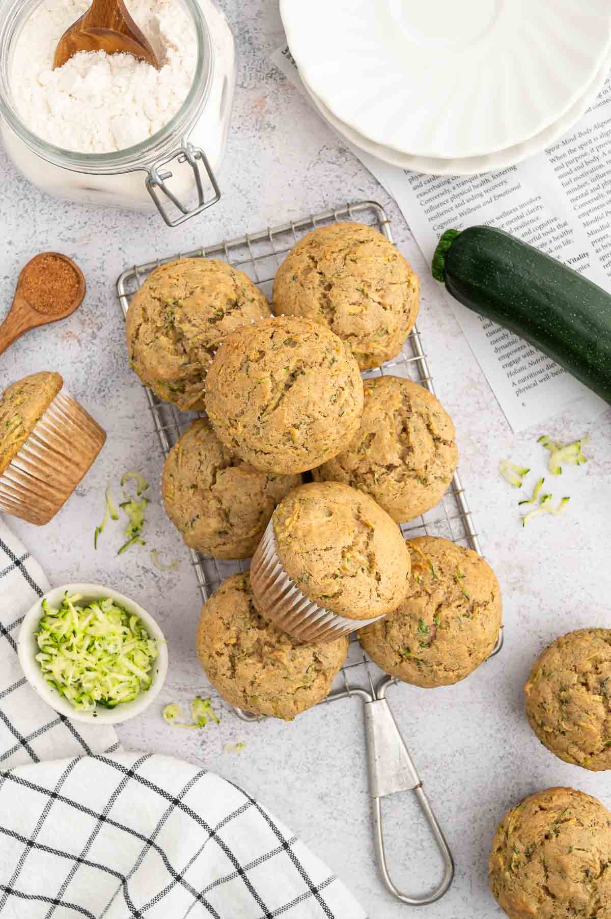 A pile of zucchini muffins on a cooling rack.