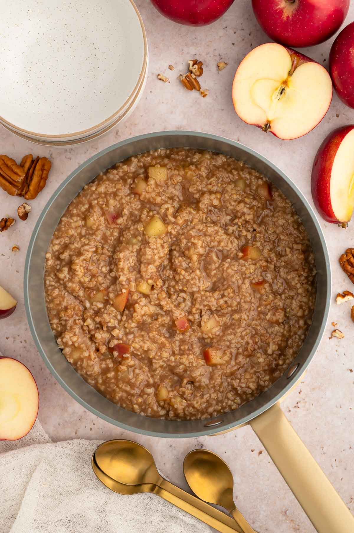 Cooked apple cinnamon oats in a saucepan.