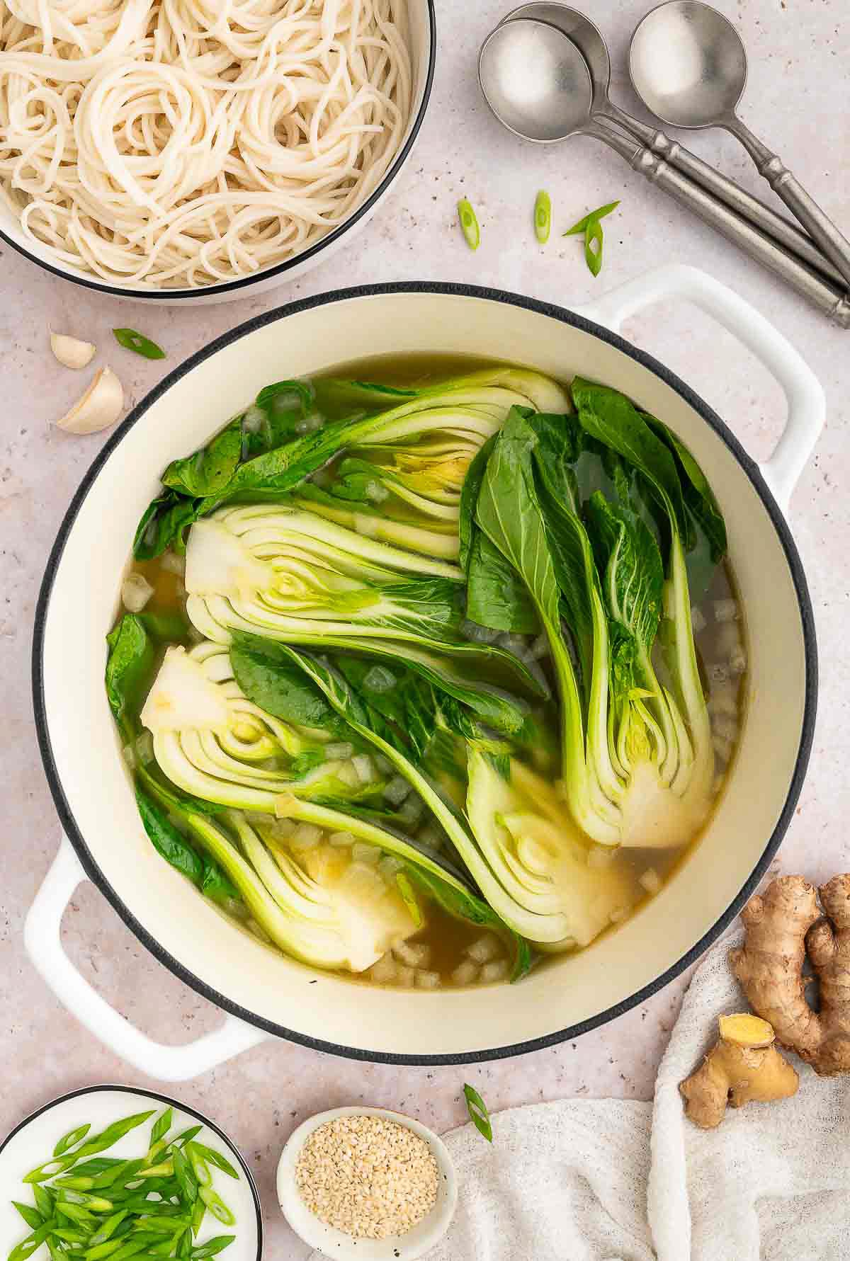 Bok choy simmering in broth.