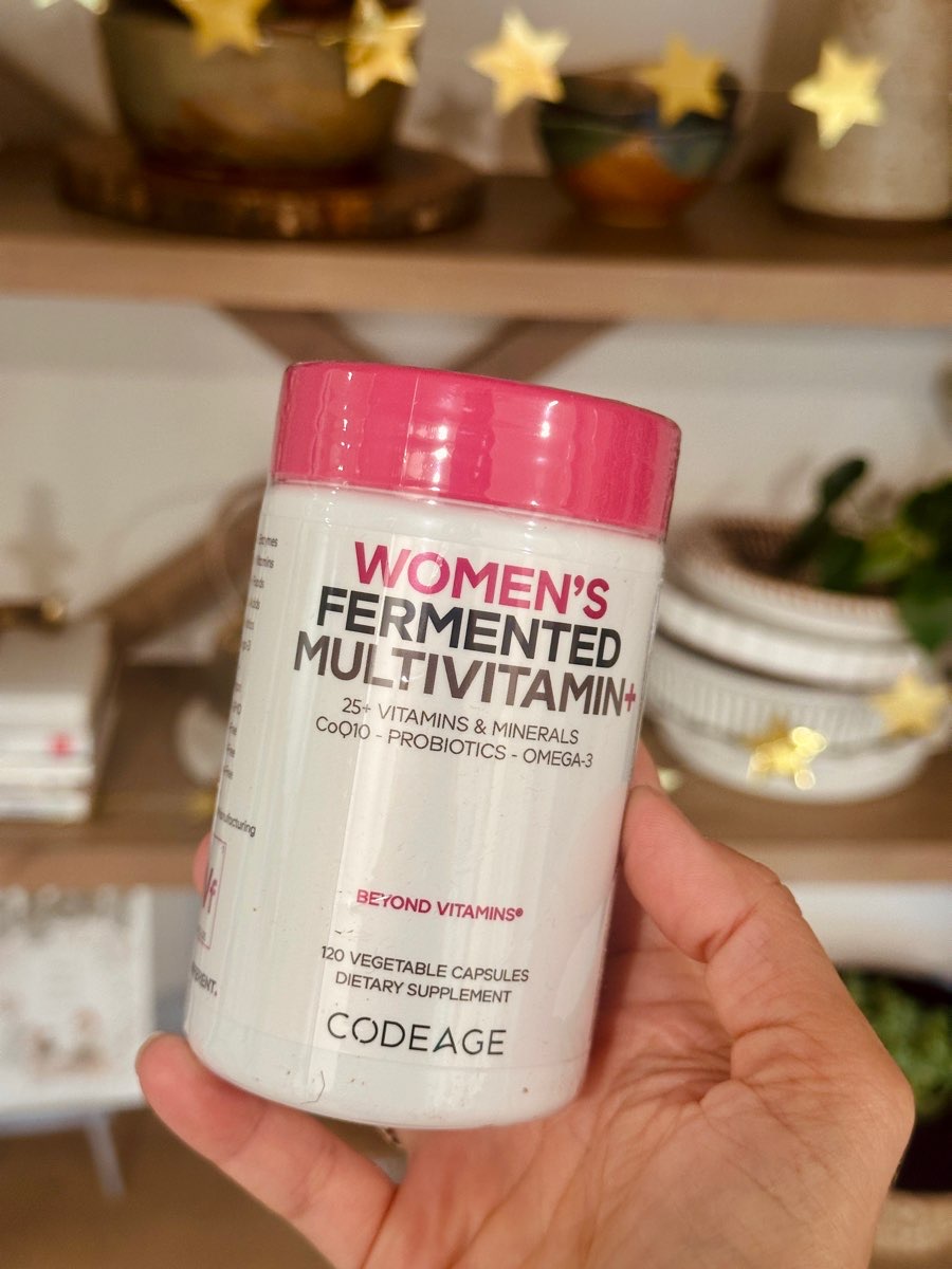 hand holding codeage women's multivitamin bottle