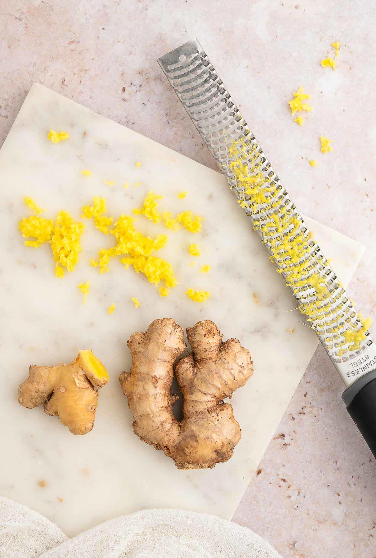 Grated ginger on a cutting board.