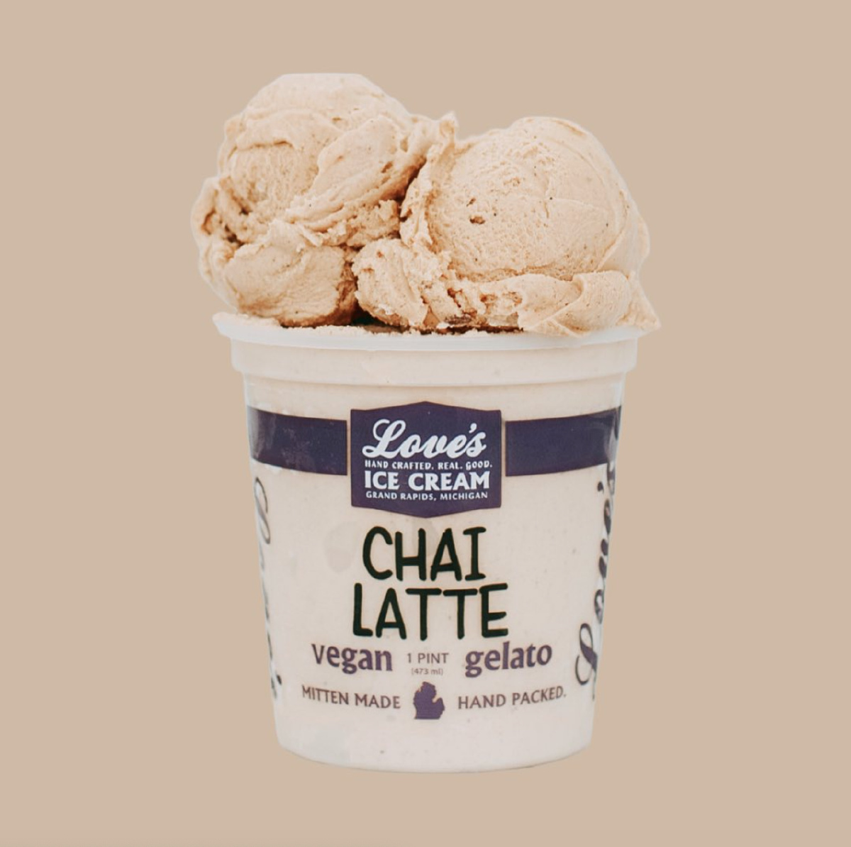 Love's Ice Cream vegan gelato in Chai Latte against a coffee colored background. 